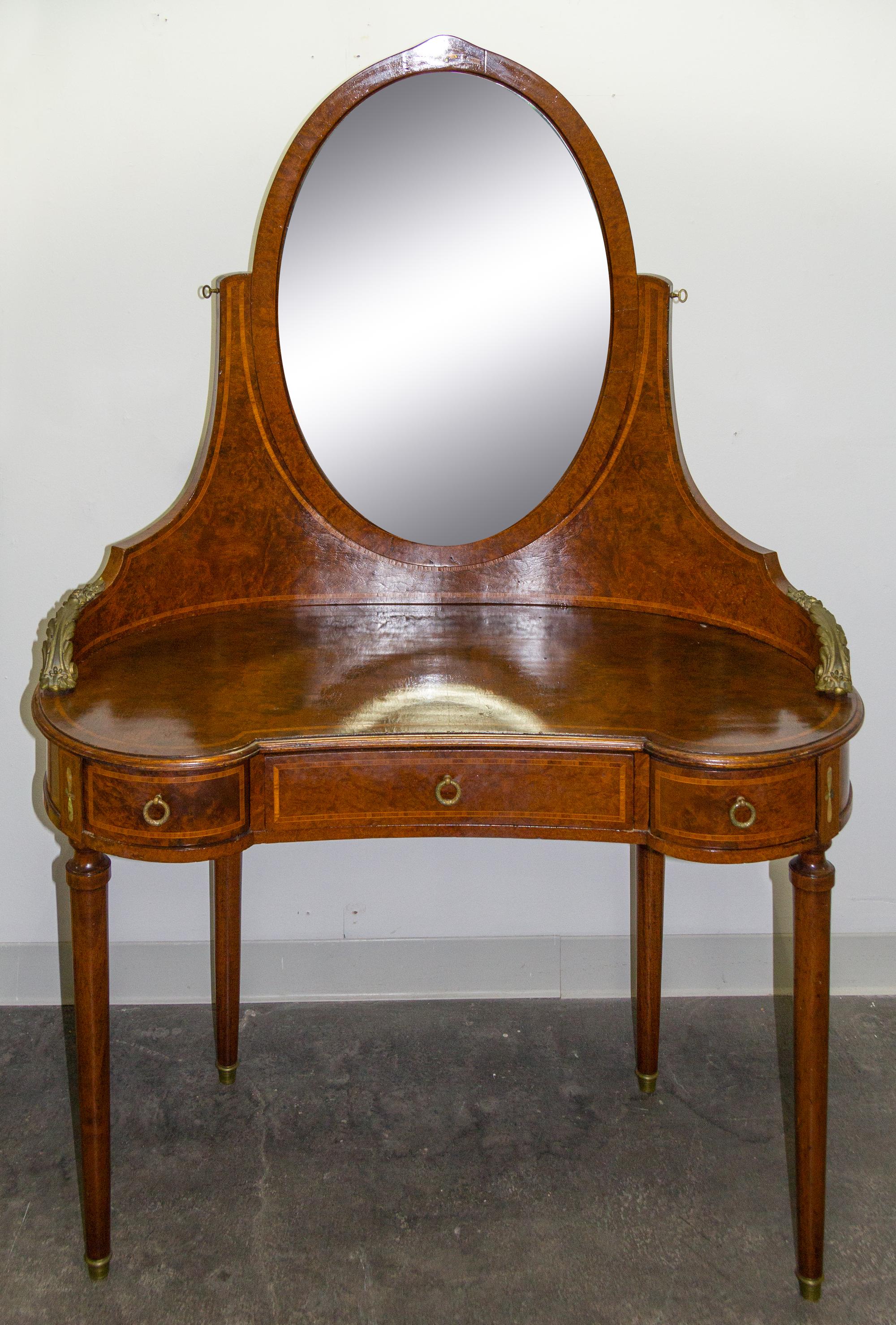 A Burlwood Mother-of-Pearl Inlaid and Gilt Metal Mounted Dressing Table Height 64 1/4 x width 44 x depth 20 inches. — 19TH/20TH CENTURY