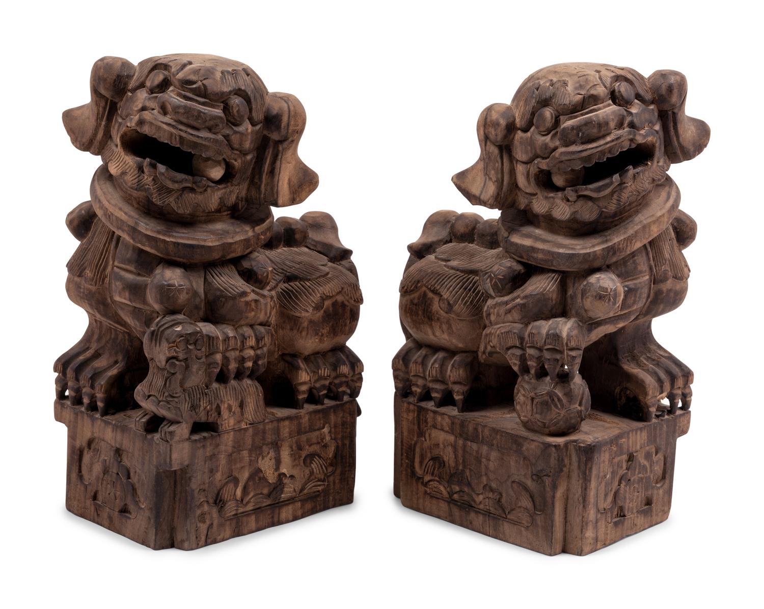 A Pair of Carved Wood Buddhistic Lions