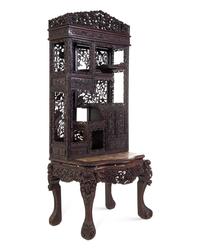 A Chinese Export Carved Hardwood Displaying Cabinet and Desk
