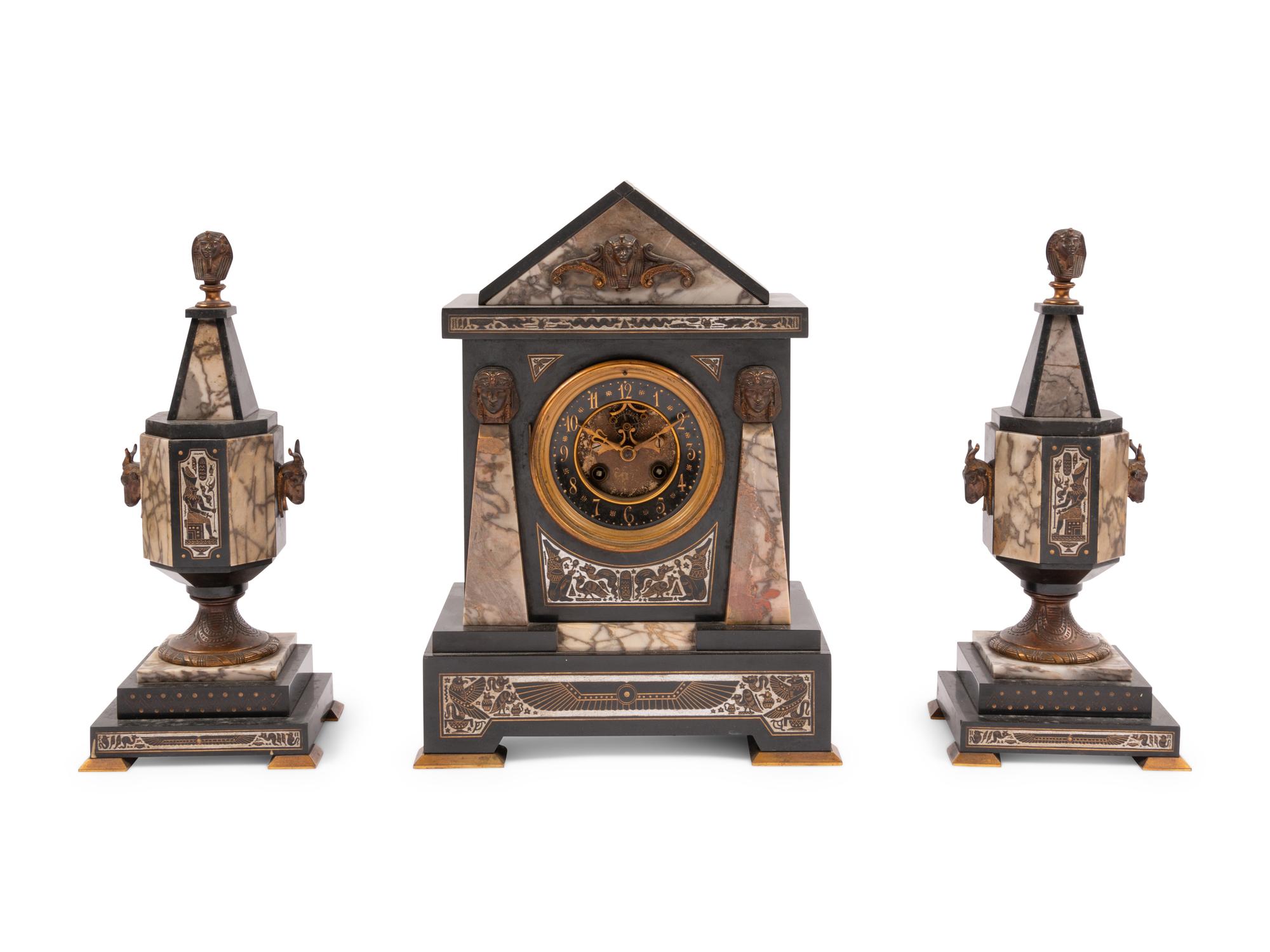 An Egyptian Revival Marble and Patinated Bronze Mantel Clock Garniture