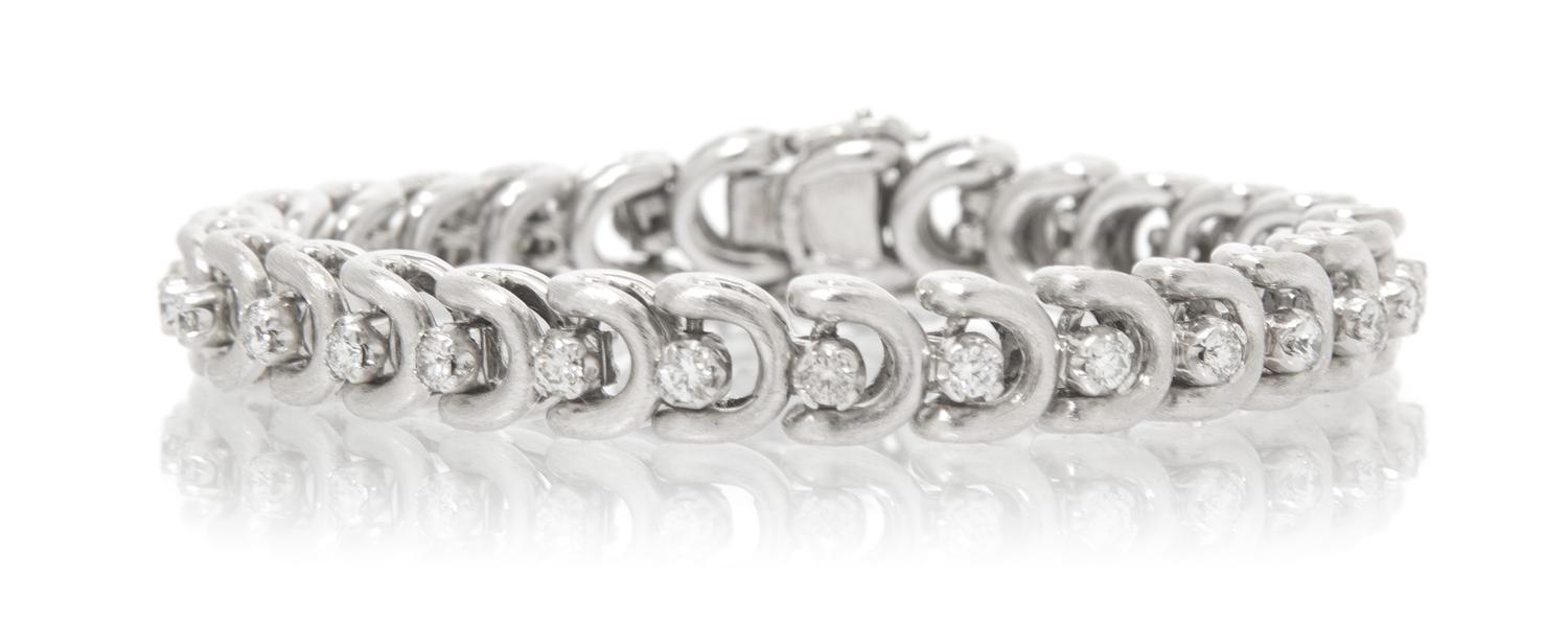 A White Gold and Diamond Line Bracelet, 22.40 dwts.