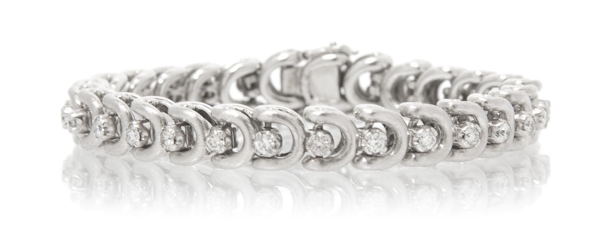 A White Gold and Diamond Line Bracelet, 22.40 dwts.