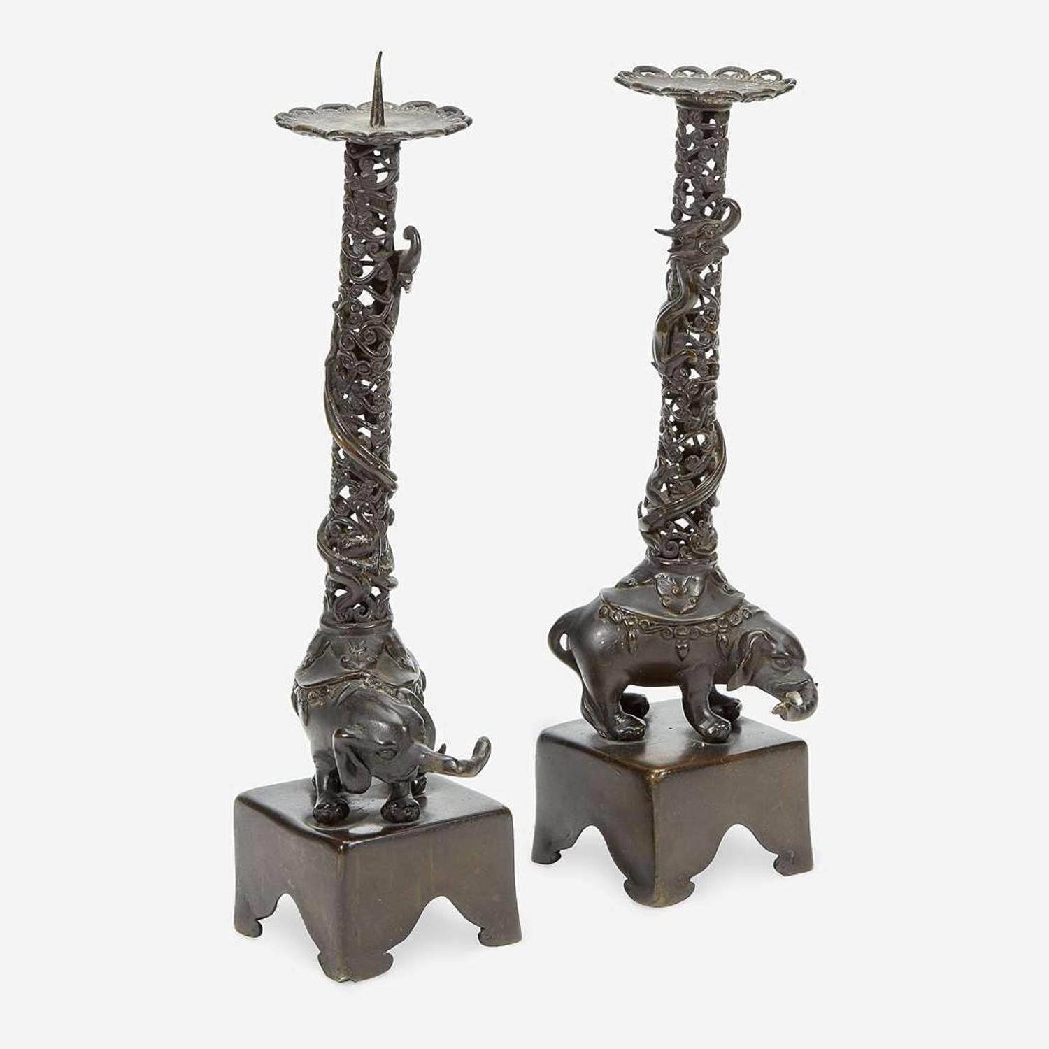 A pair of Japanese "Elephant and Dragon" patinated bronze openwork pricket candlesticks Edo period, 18th/early 19th Century