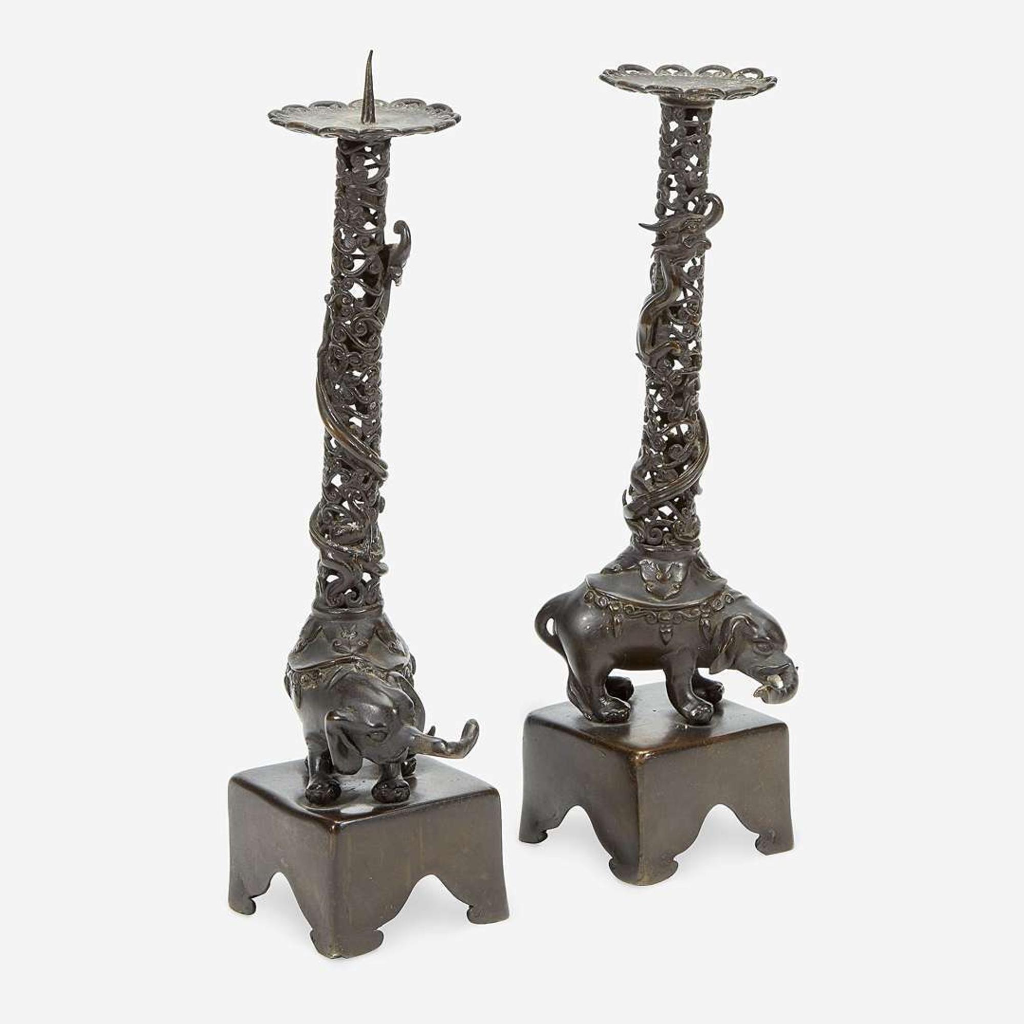 A pair of Japanese "Elephant and Dragon" patinated bronze openwork pricket candlesticks Edo period, 18th/early 19th Century