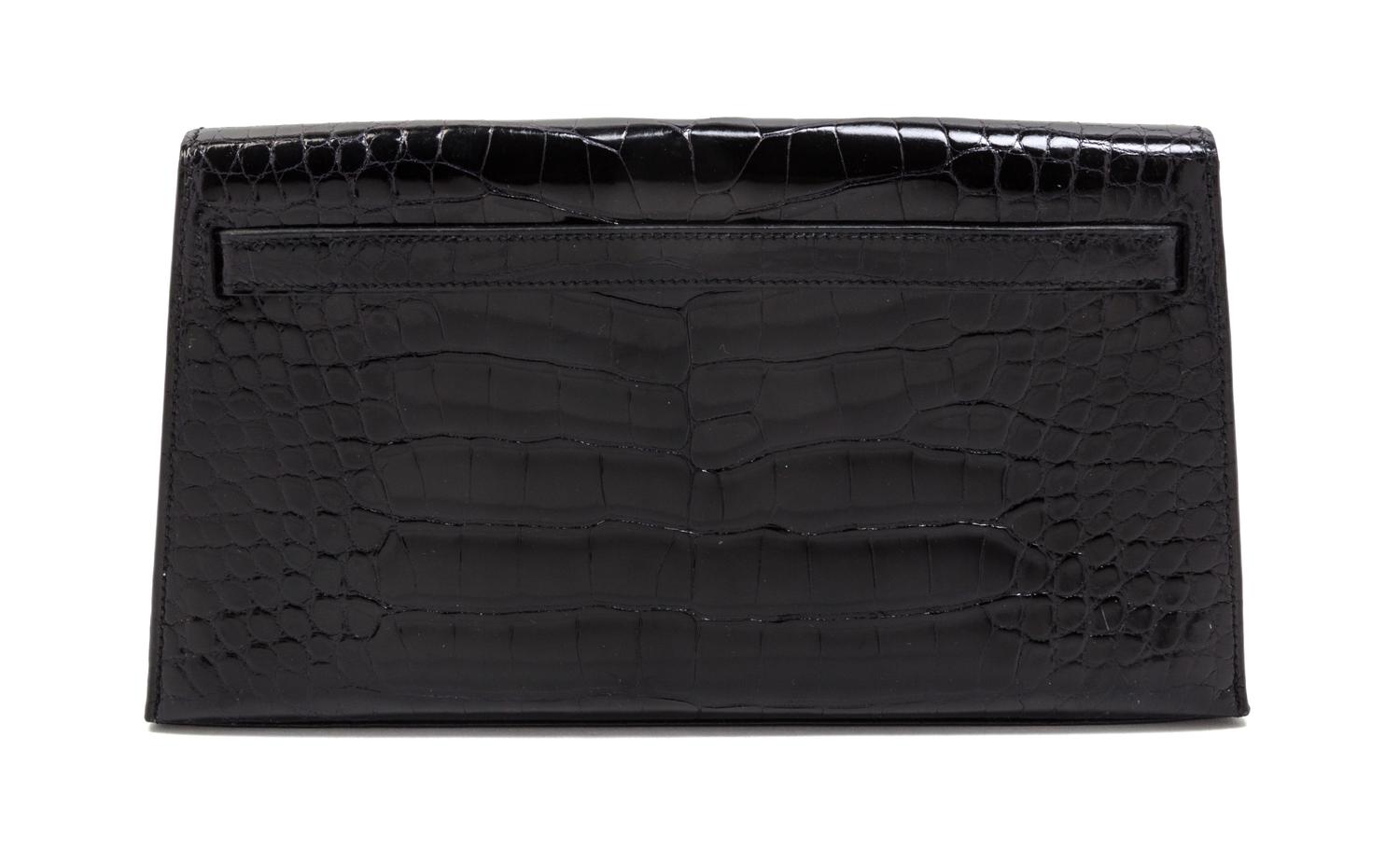 An Hermes Black Shiny Alligator Kelly Clutch Bag, 11 x 6 x 1 1/2 inches.
