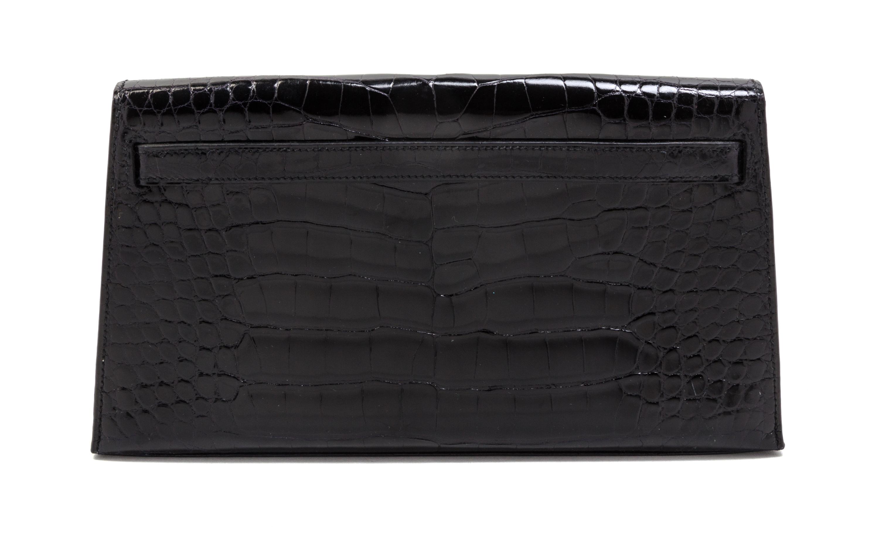 An Hermes Black Shiny Alligator Kelly Clutch Bag, 11 x 6 x 1 1/2 inches.