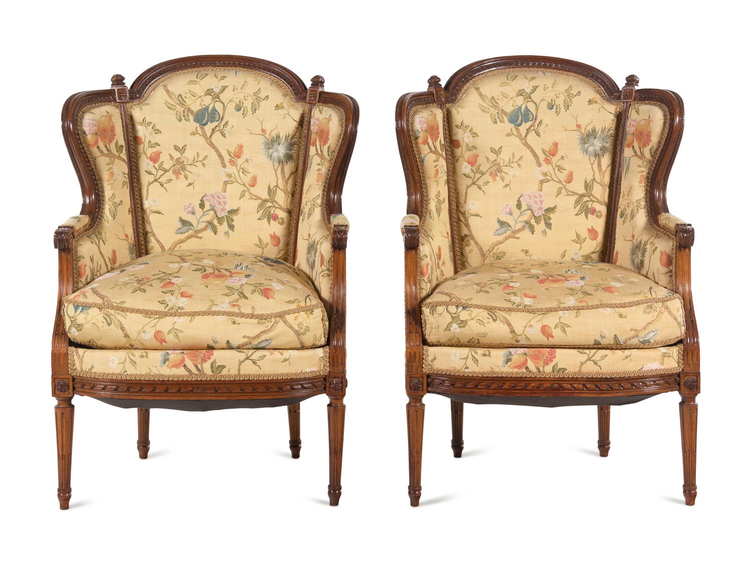 A Pair of Louis XVI Style Carved Walnut Bergères