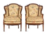 A Pair of Louis XVI Style Carved Walnut Bergères