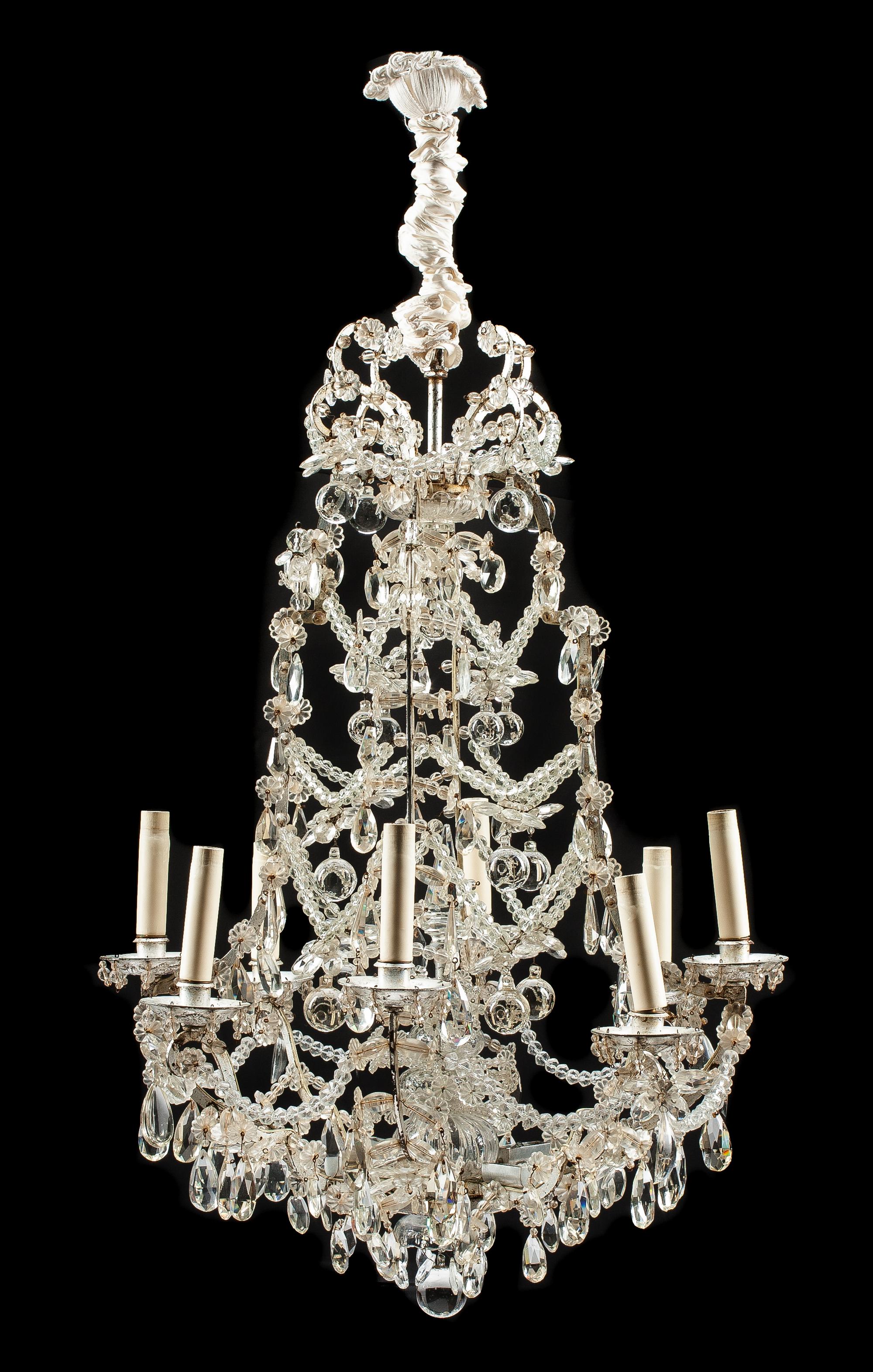 A Louis XV Style Silvered Eight-Light Chandelier Height 47 x diameter 28 inches.