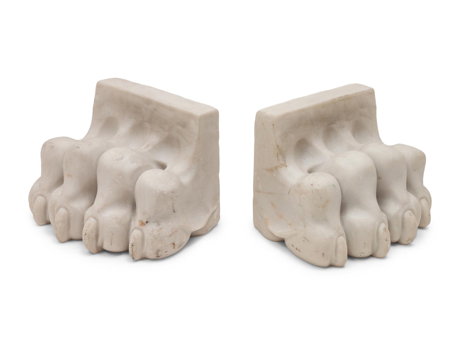 A Pair of Composition and Bronze Paw and Foot Form Doorstops