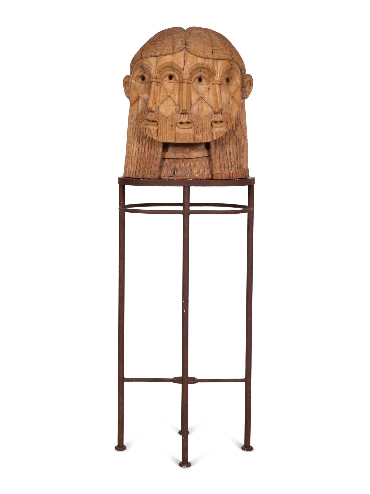 A Carved Wood Sculpture of a Three-Faced Man