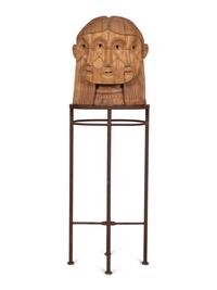 A Carved Wood Sculpture of a Three-Faced Man