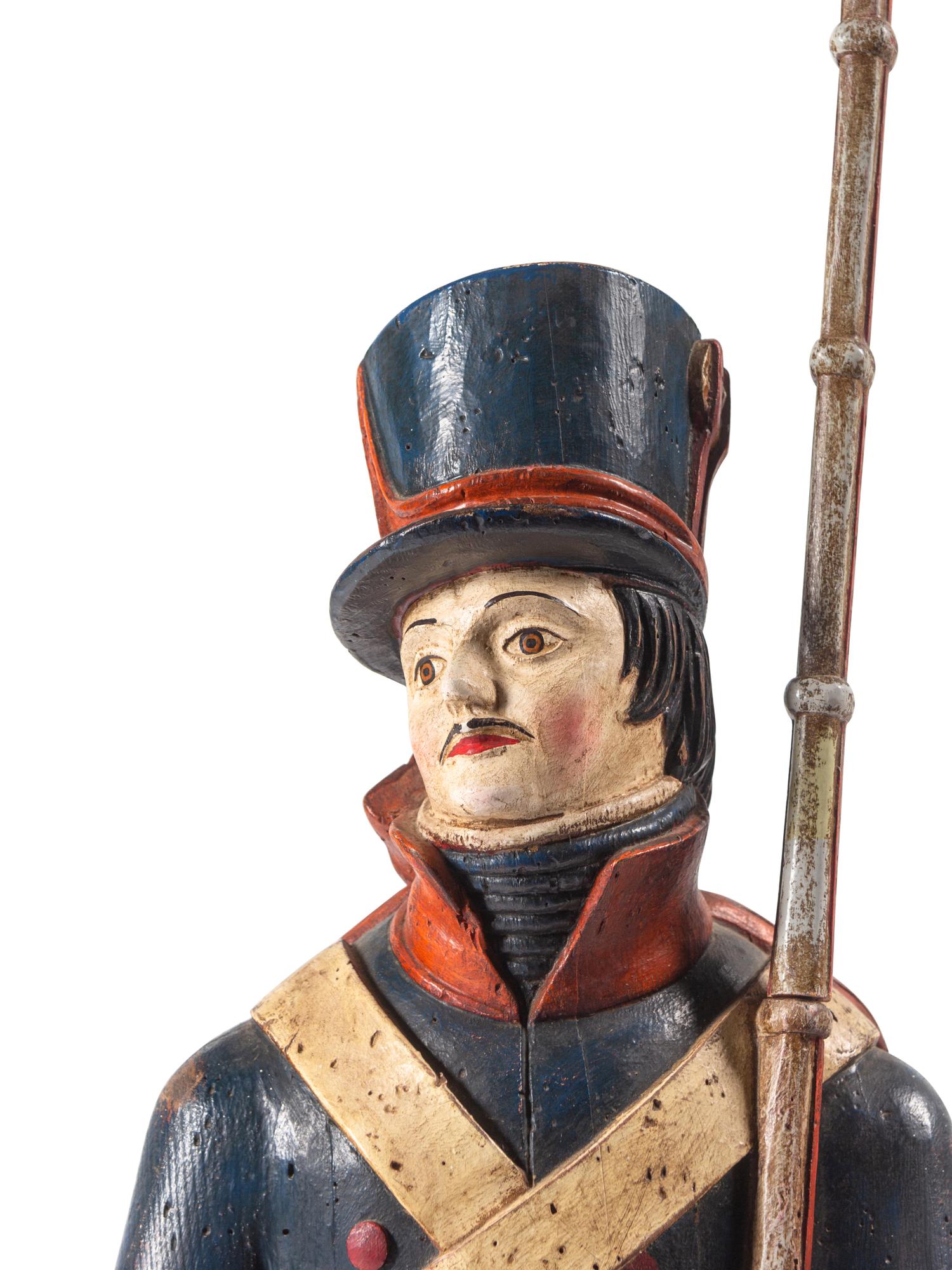 A Carved and Painted Wood Figure of a Soldier
