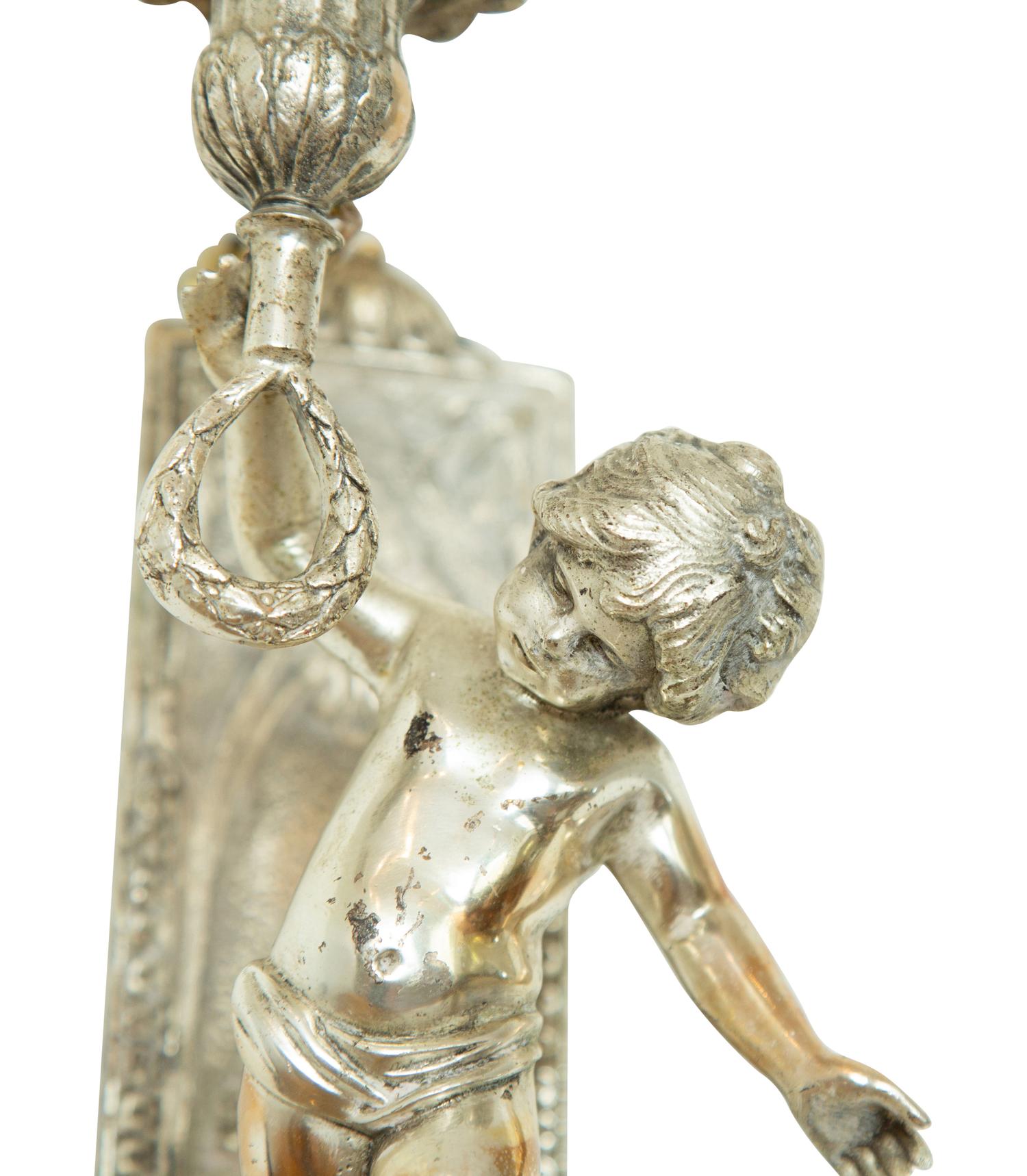 A Pair of Continental Silvered Metal Figural Wall Lights