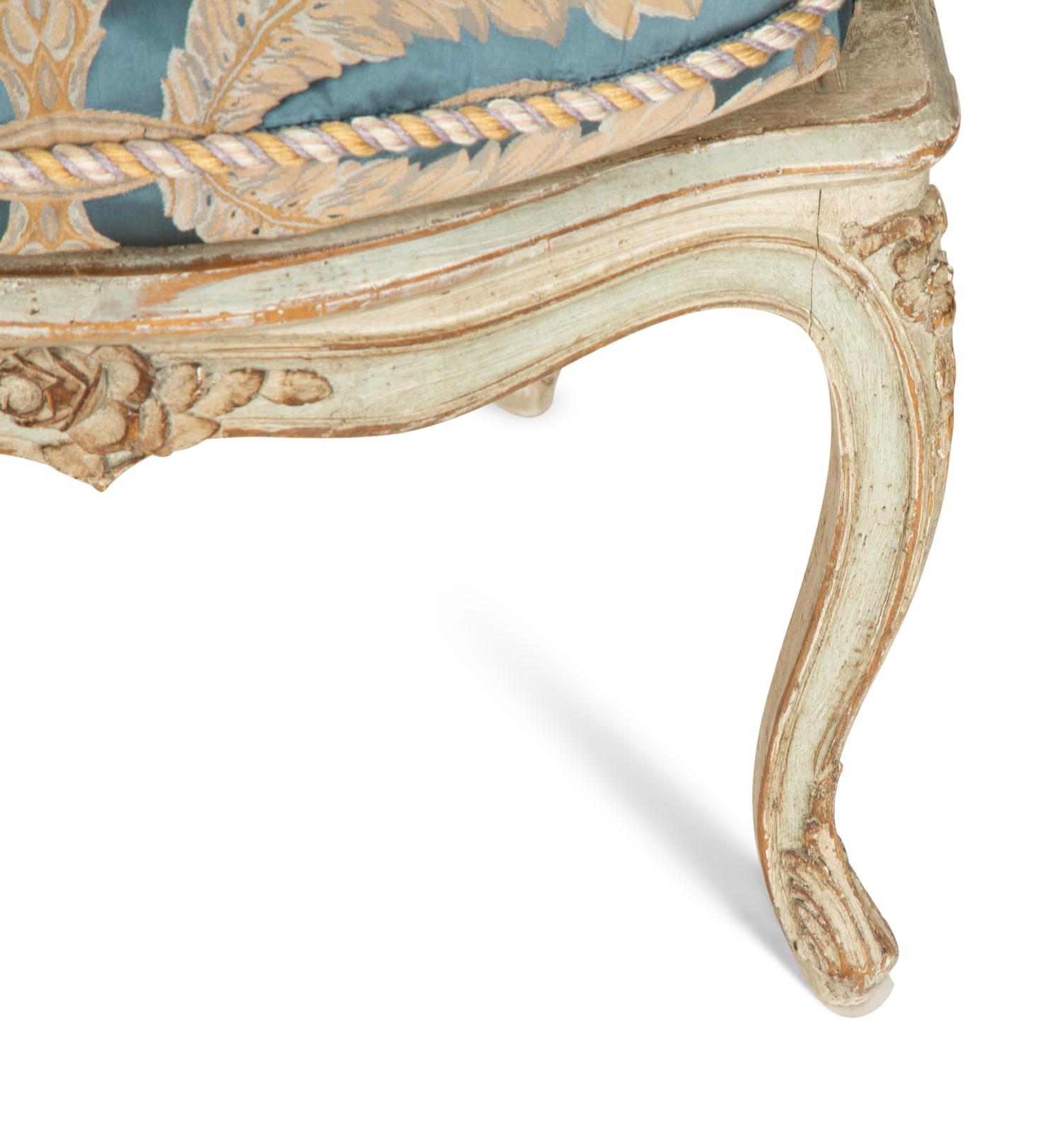 A Pair of Louis XV Blue Painted Cane-Backed Fauteuils