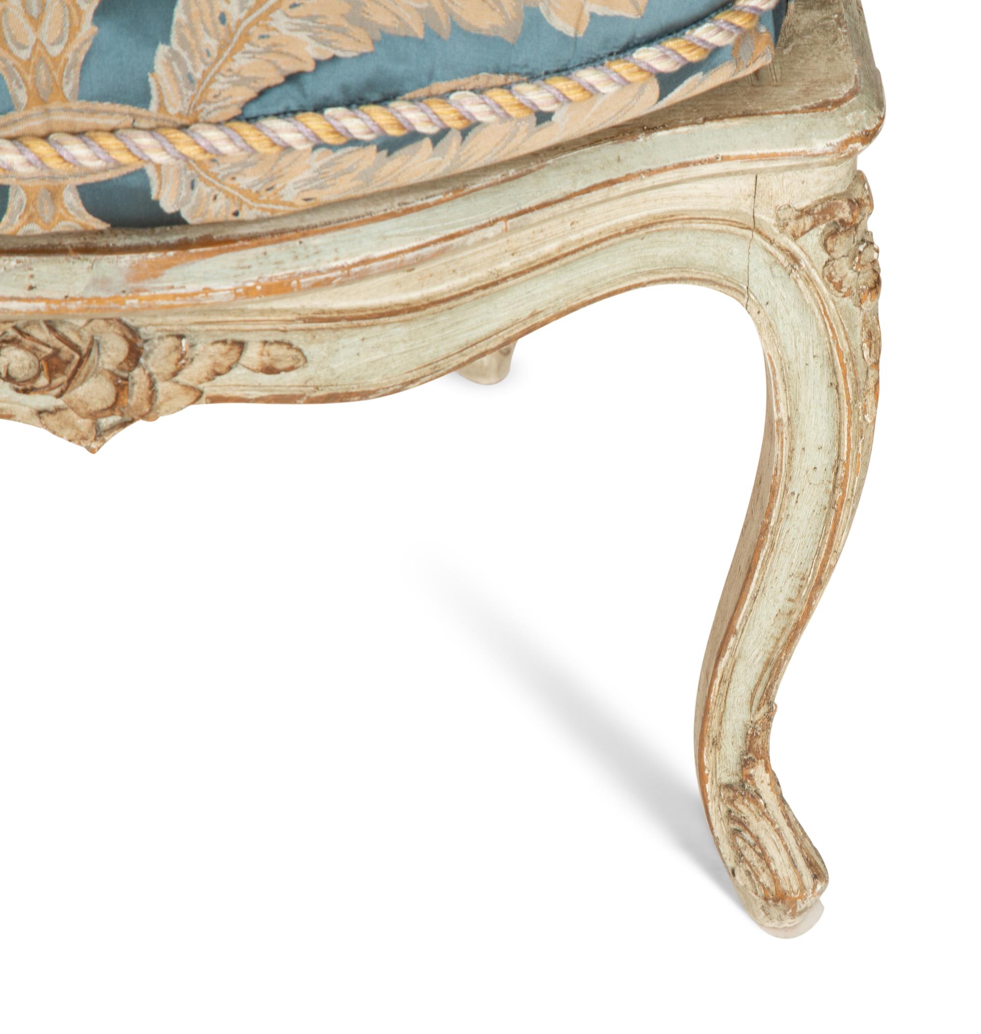 A Pair of Louis XV Blue Painted Cane-Backed Fauteuils