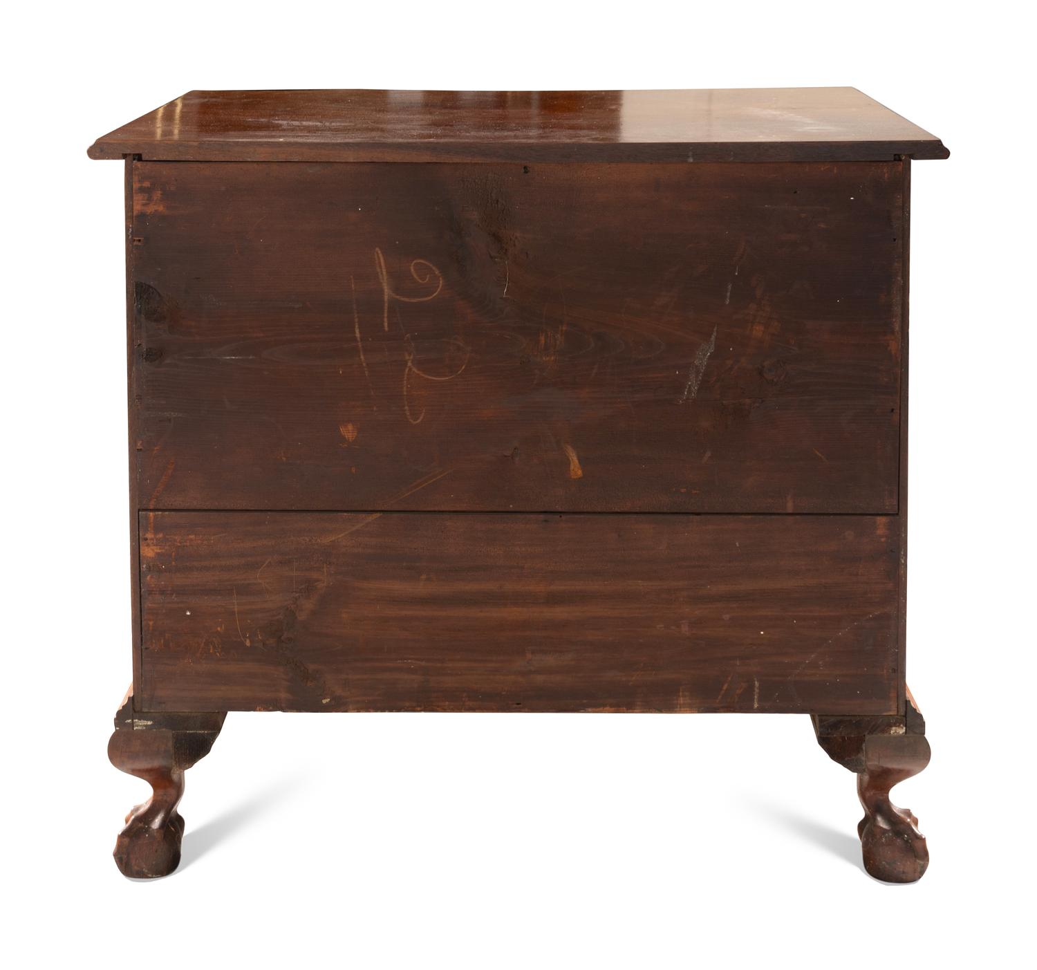 A Chippendale Carved And Figured Mahogany Serpentine Chest Of Drawers