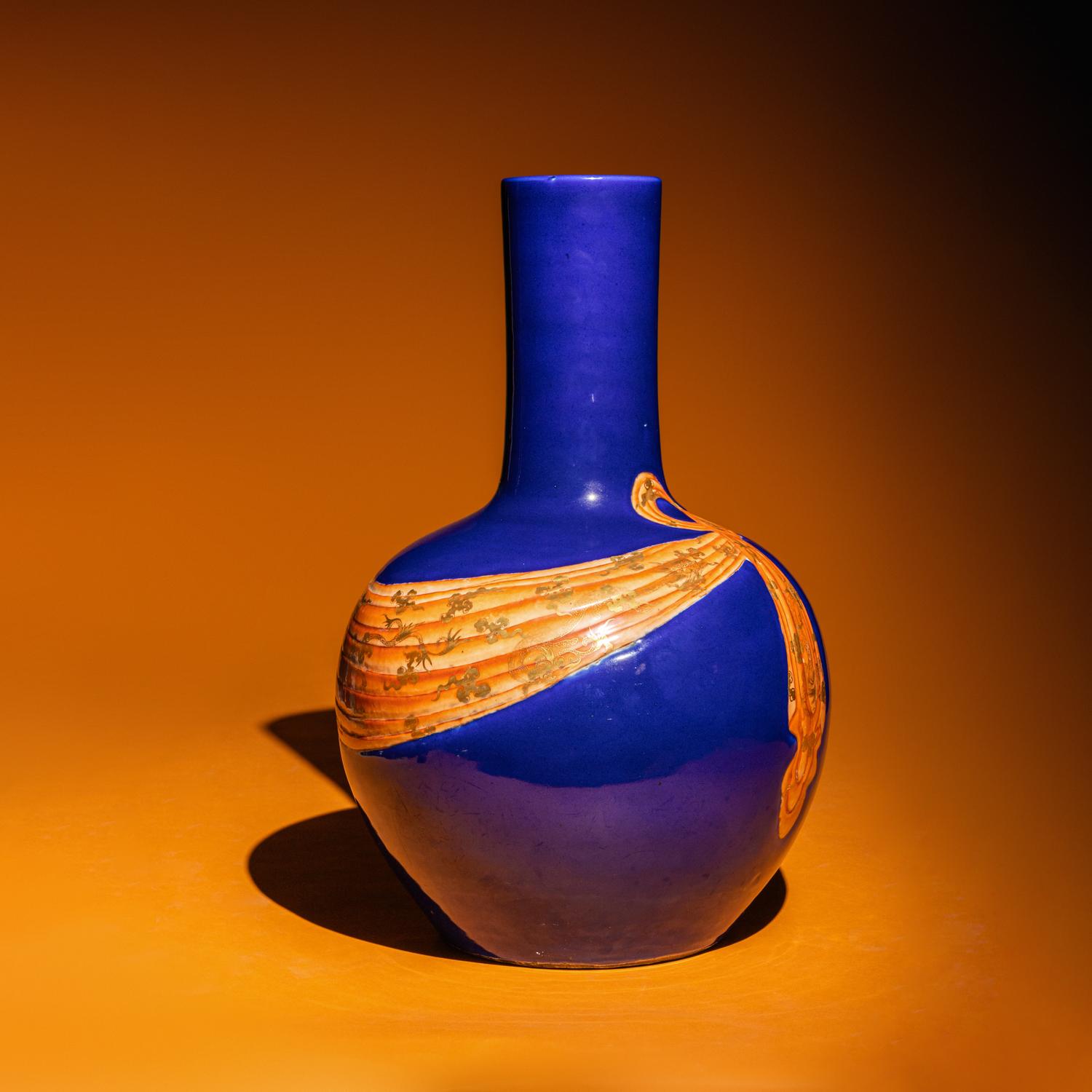 A Large Chinese Gilt and Iron Red Highlighted Blue Glazed Porcelain 'Ribbon-Tied' Vase, Tianqiuping, Late Qing Dynasty/Early Republic Period 晚清/民國 藍地描金包袱式天球瓶