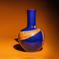 A Large Chinese Gilt and Iron Red Highlighted Blue Glazed Porcelain 'Ribbon-Tied' Vase, Tianqiuping, Late Qing Dynasty/Early Republic Period 晚清/民國 藍地描金包袱式天球瓶