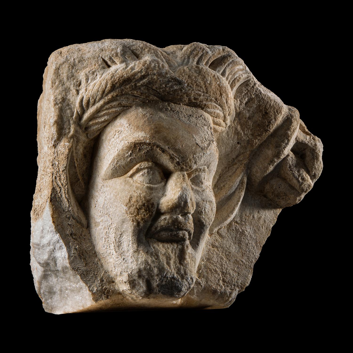 A Roman Marble Relief Fragment with the Head of a Satyr