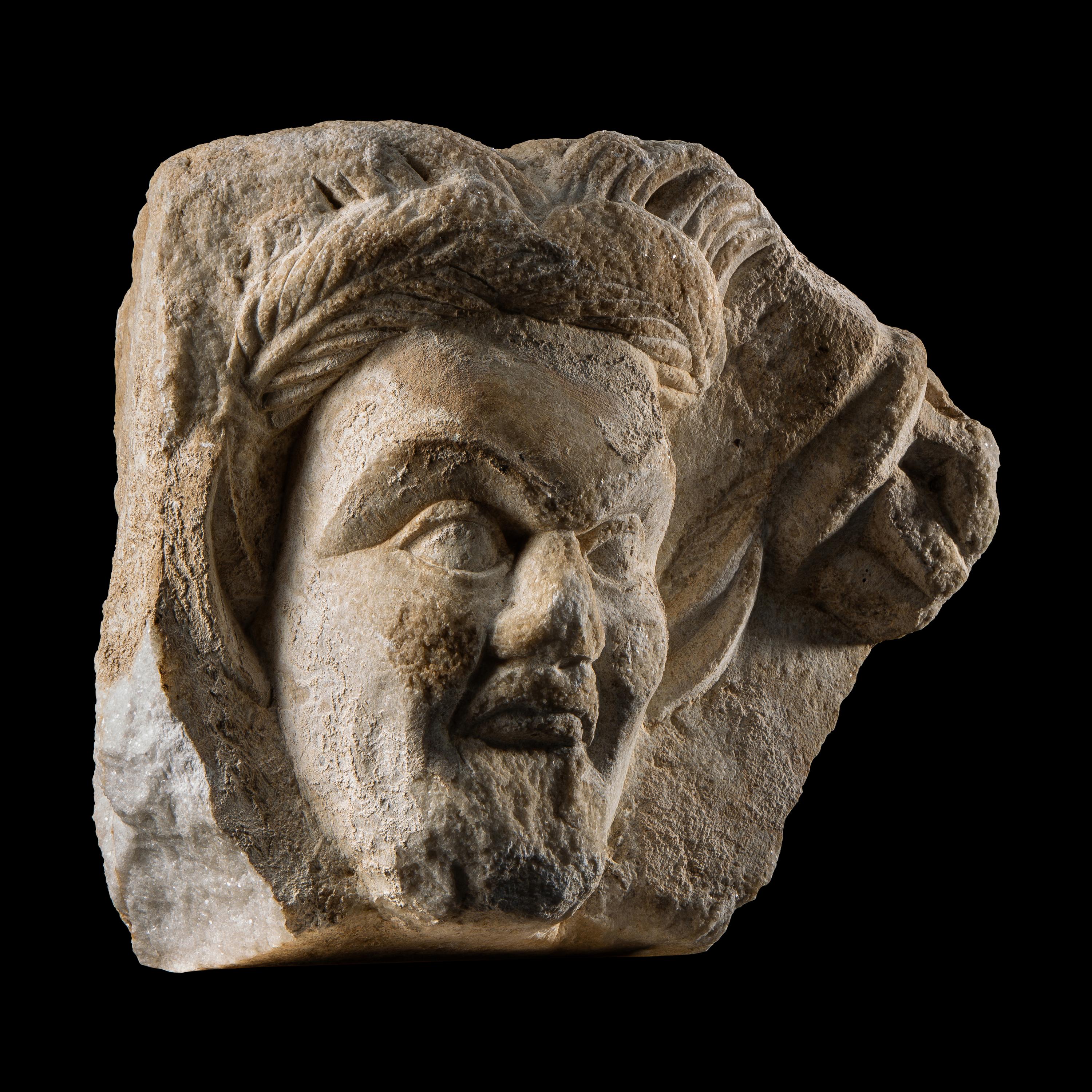 A Roman Marble Relief Fragment with the Head of a Satyr