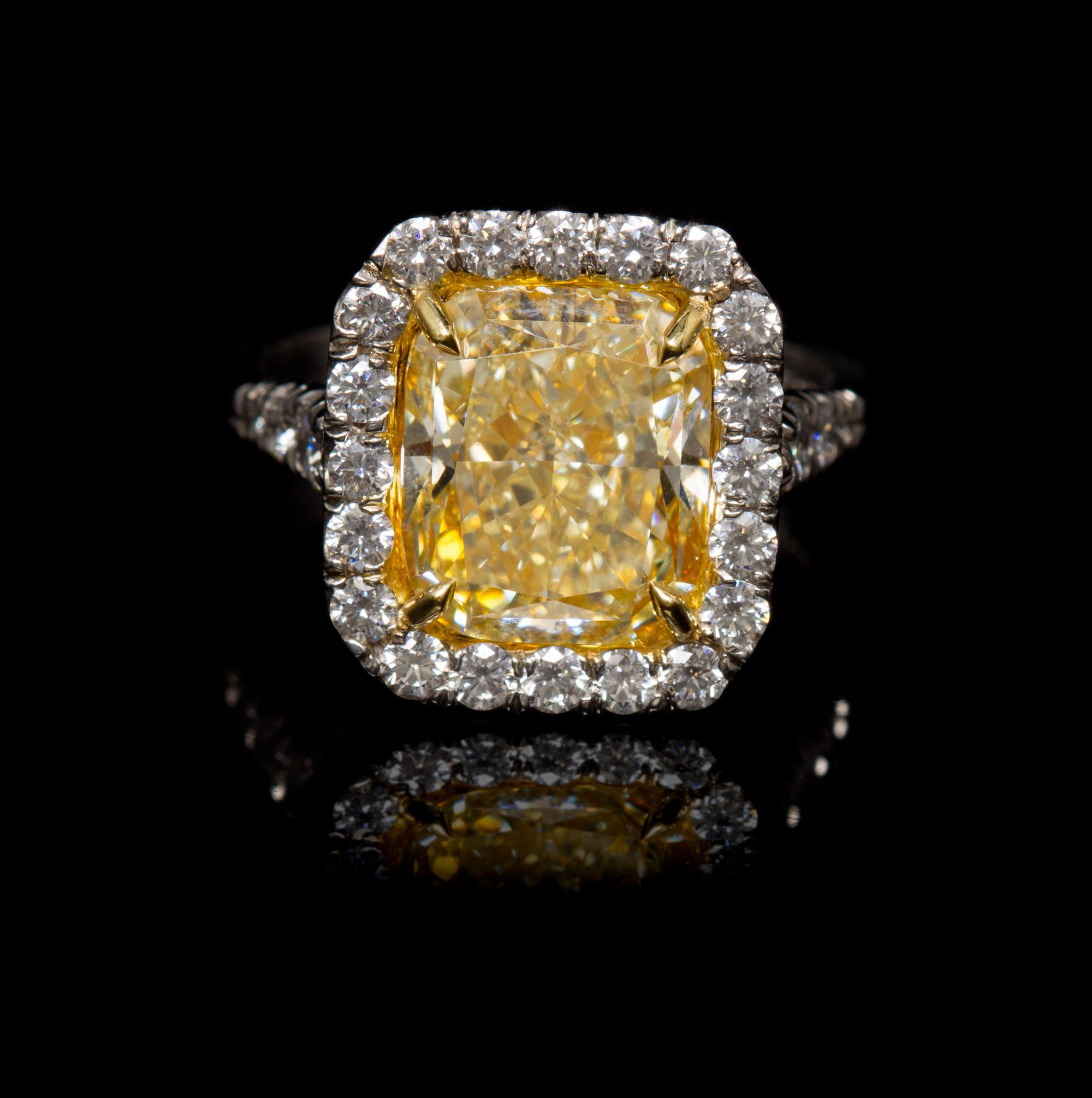 A Platinum, Yellow Gold, Fancy Intense Yellow Diamond and Diamond Ring, 5.60 dwts.