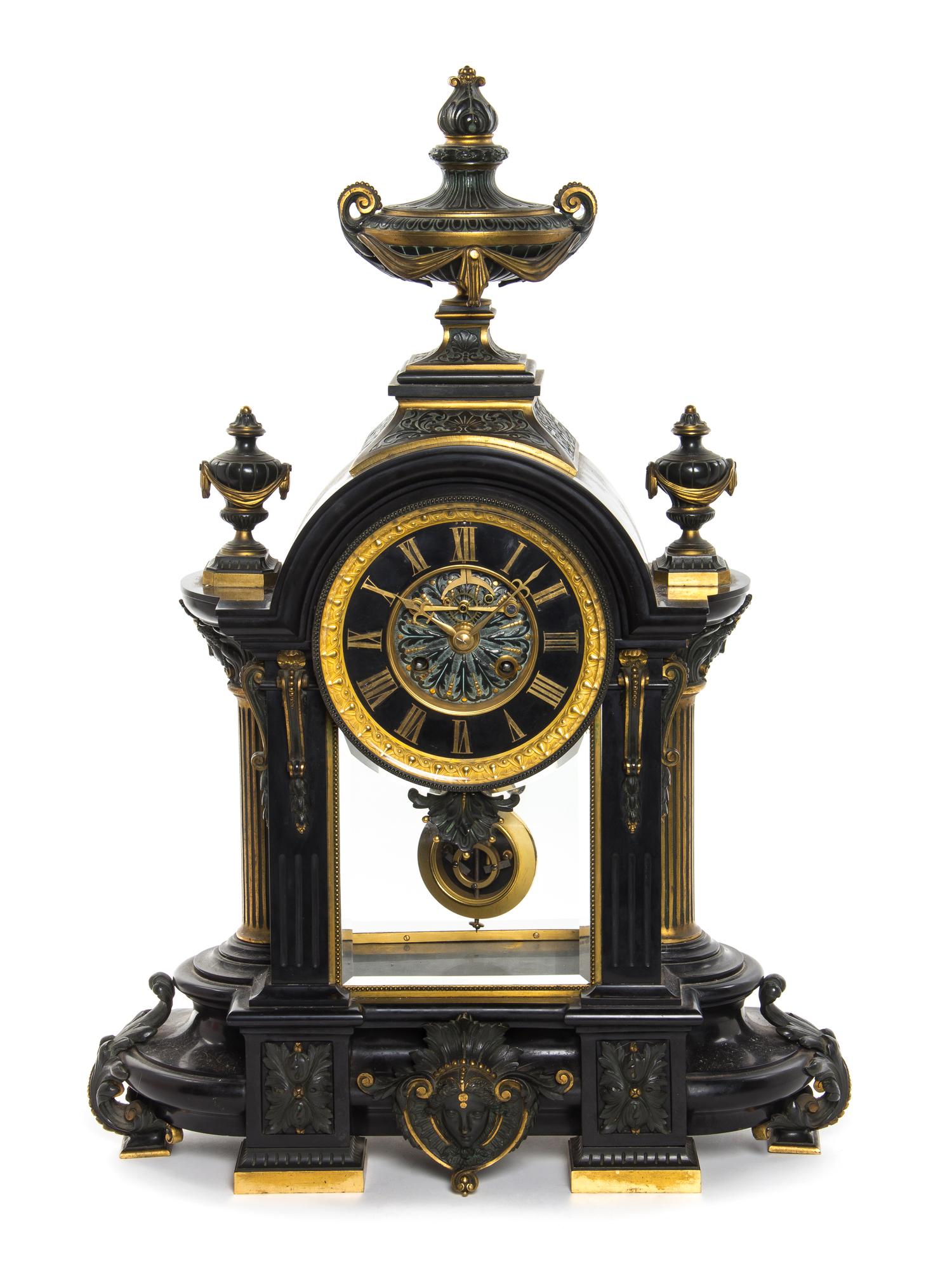 A French Neoclassical Ebonized Bronze and Slate Mantel Clock, Height 27 inches.