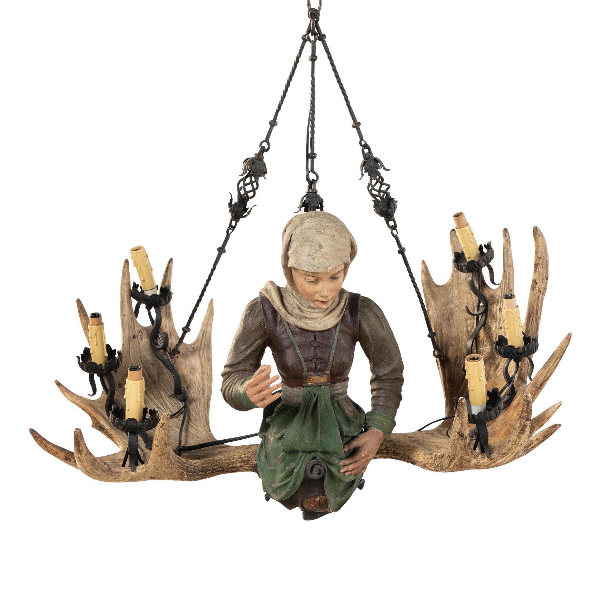 An Austrian Carved Wood and Antler Figural Chandelier