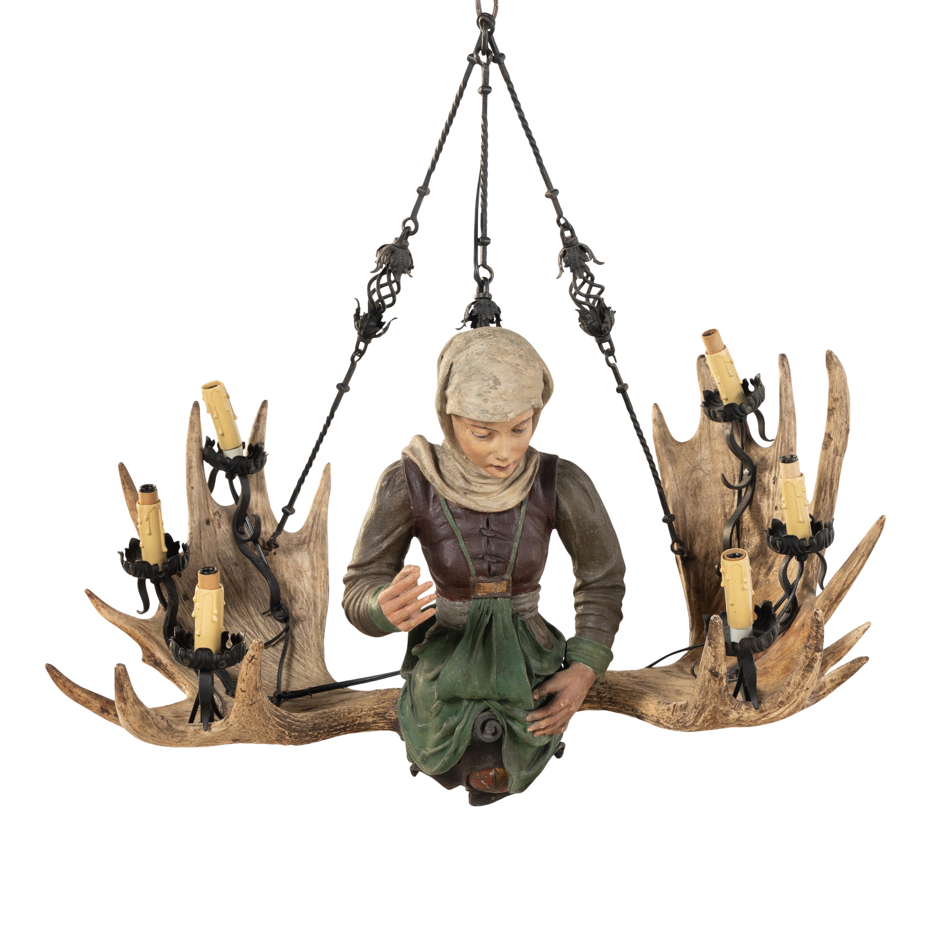 An Austrian Carved Wood and Antler Figural Chandelier