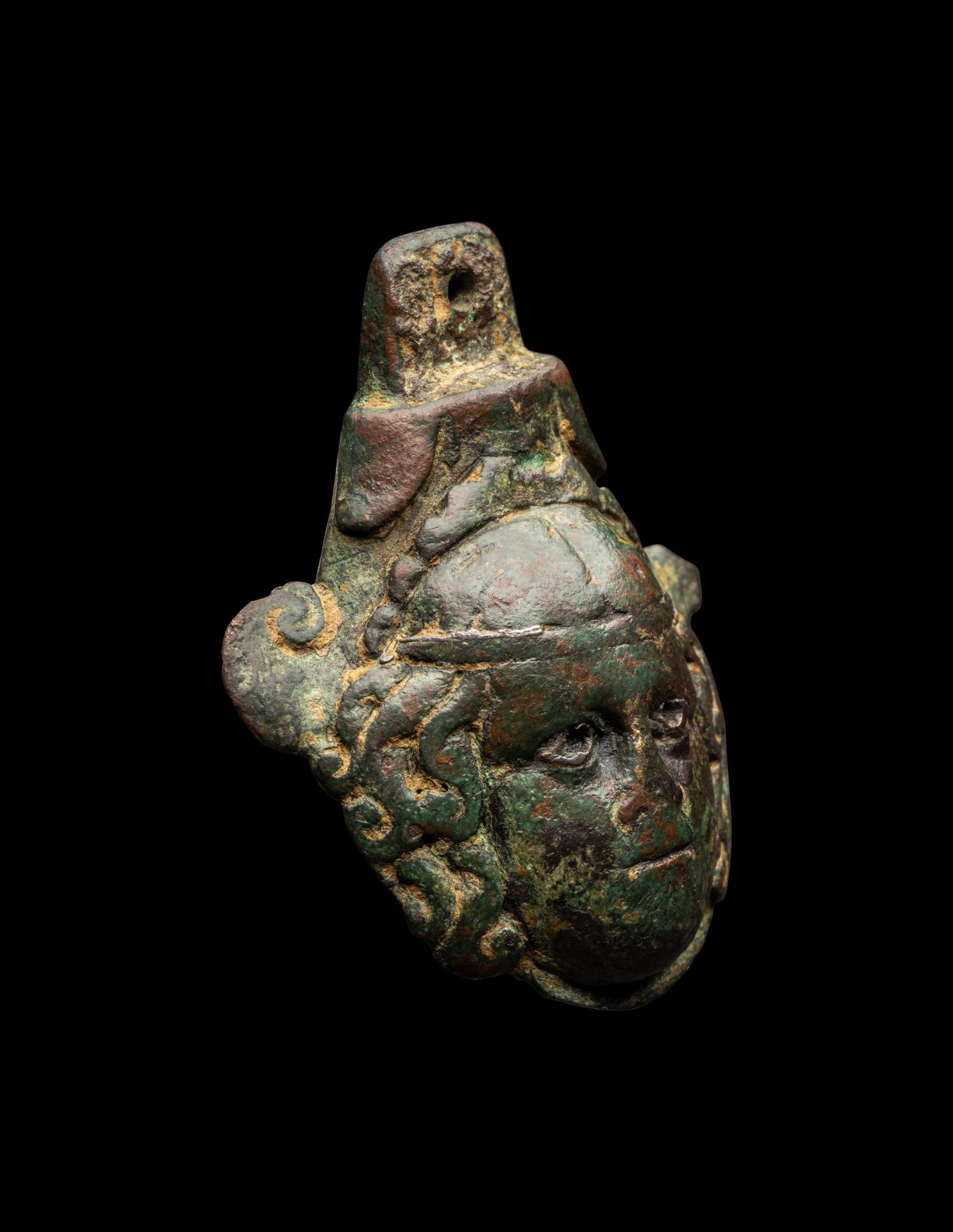 A Roman Bronze Terminal in the Form of a Medusa Head with Silver Inlaid Eyes
