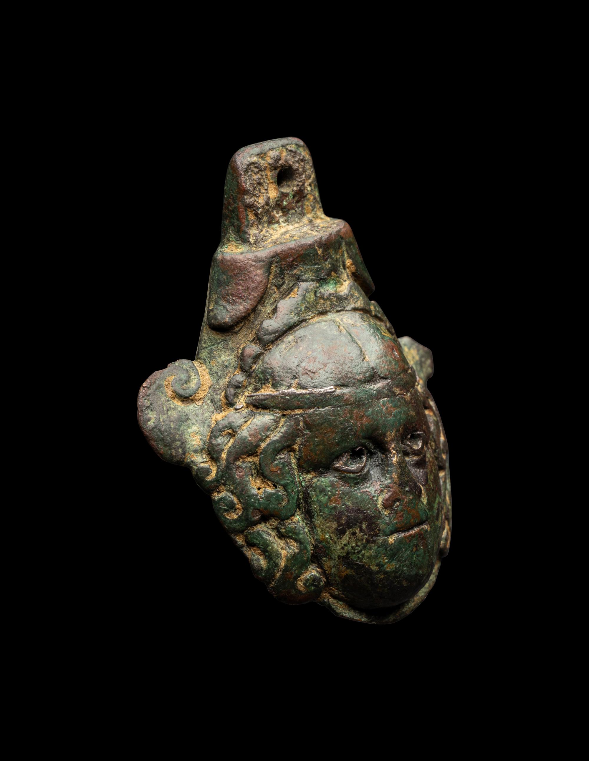 A Roman Bronze Terminal in the Form of a Medusa Head with Silver Inlaid Eyes