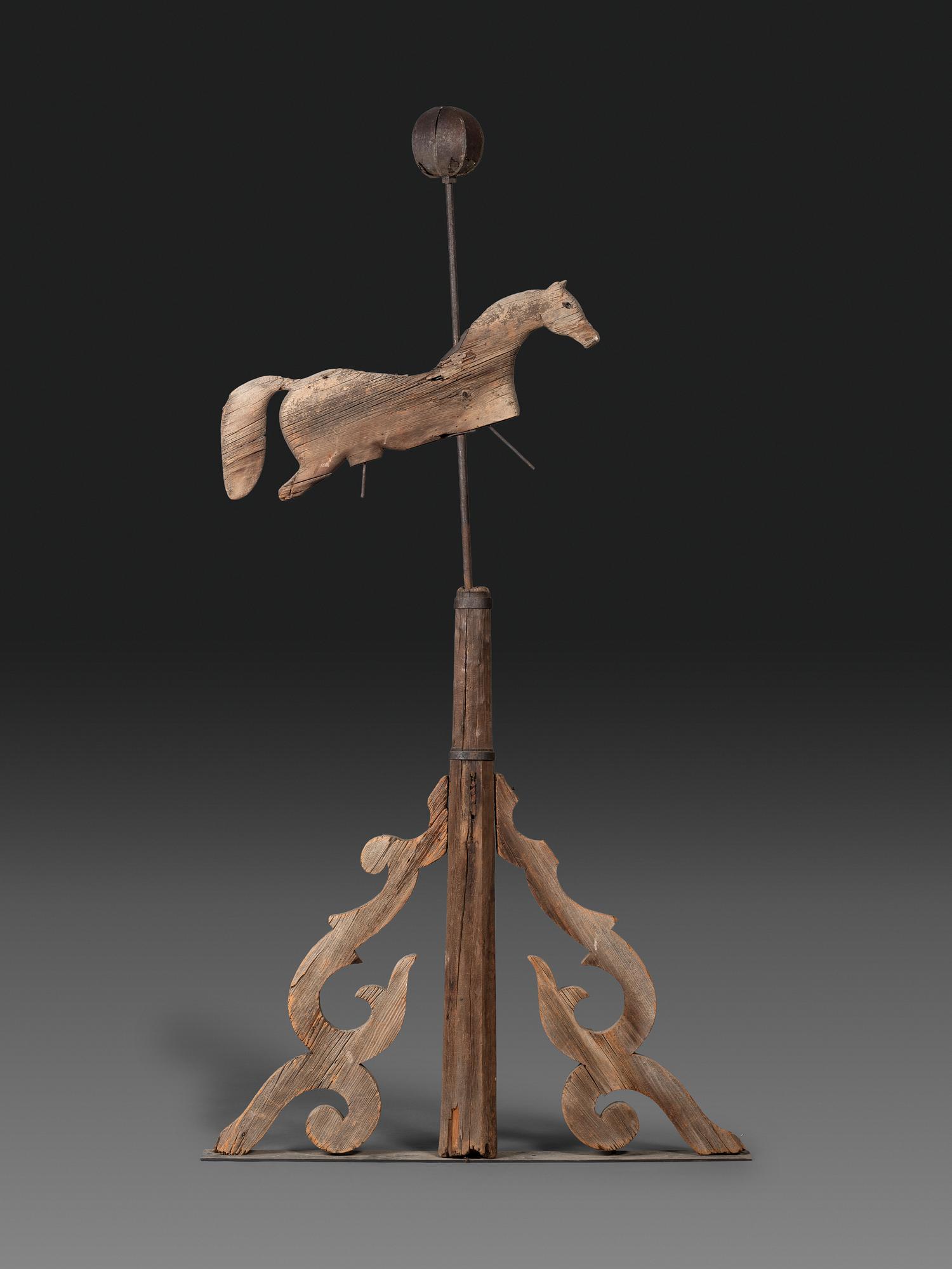 A Primitive Carved Pine and Cast Iron Horse Weathervane on Stand