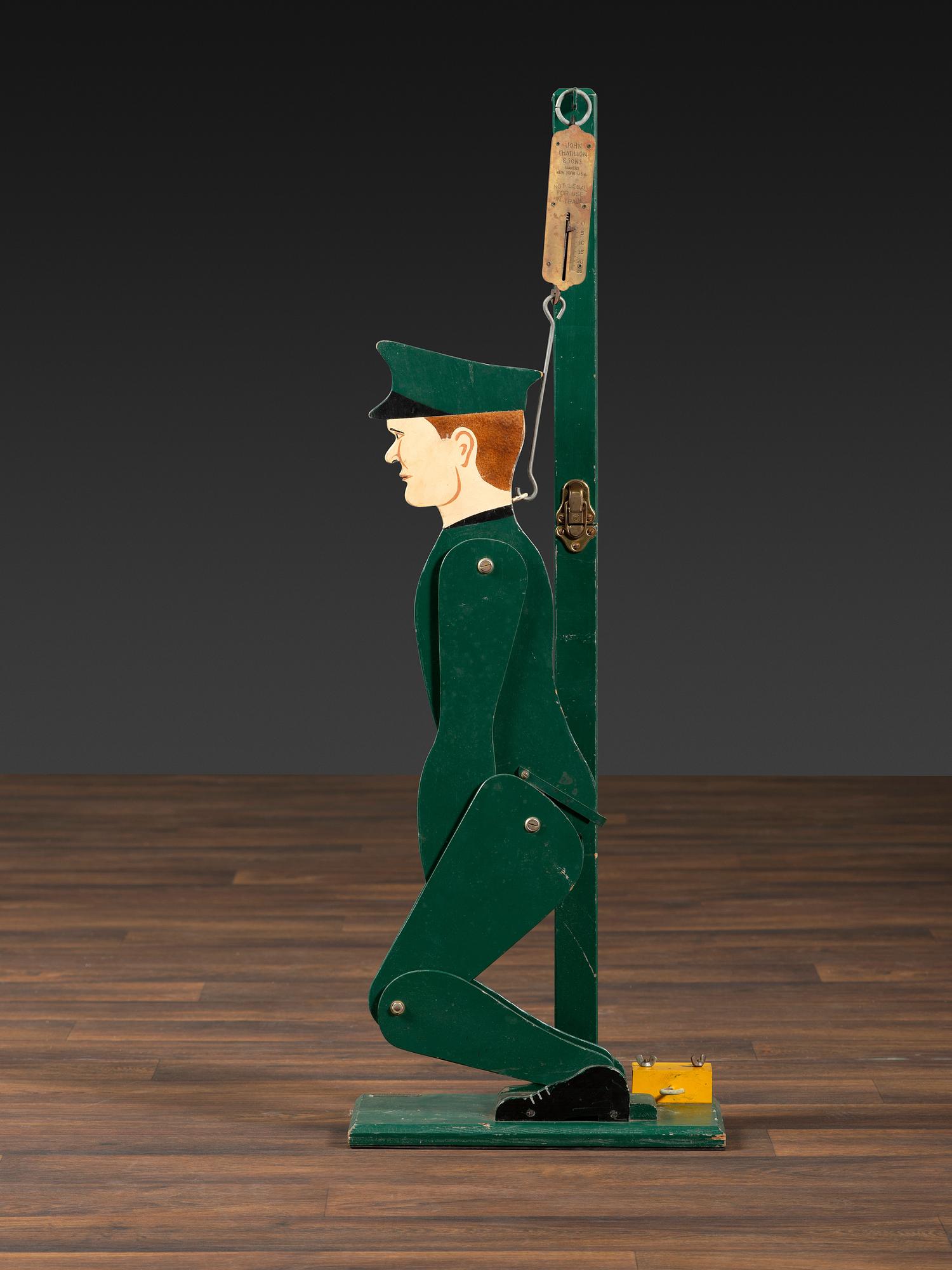 A Carved and Painted Wood Figural Post Office Scale
