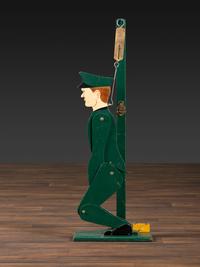 A Carved and Painted Wood Figural Post Office Scale