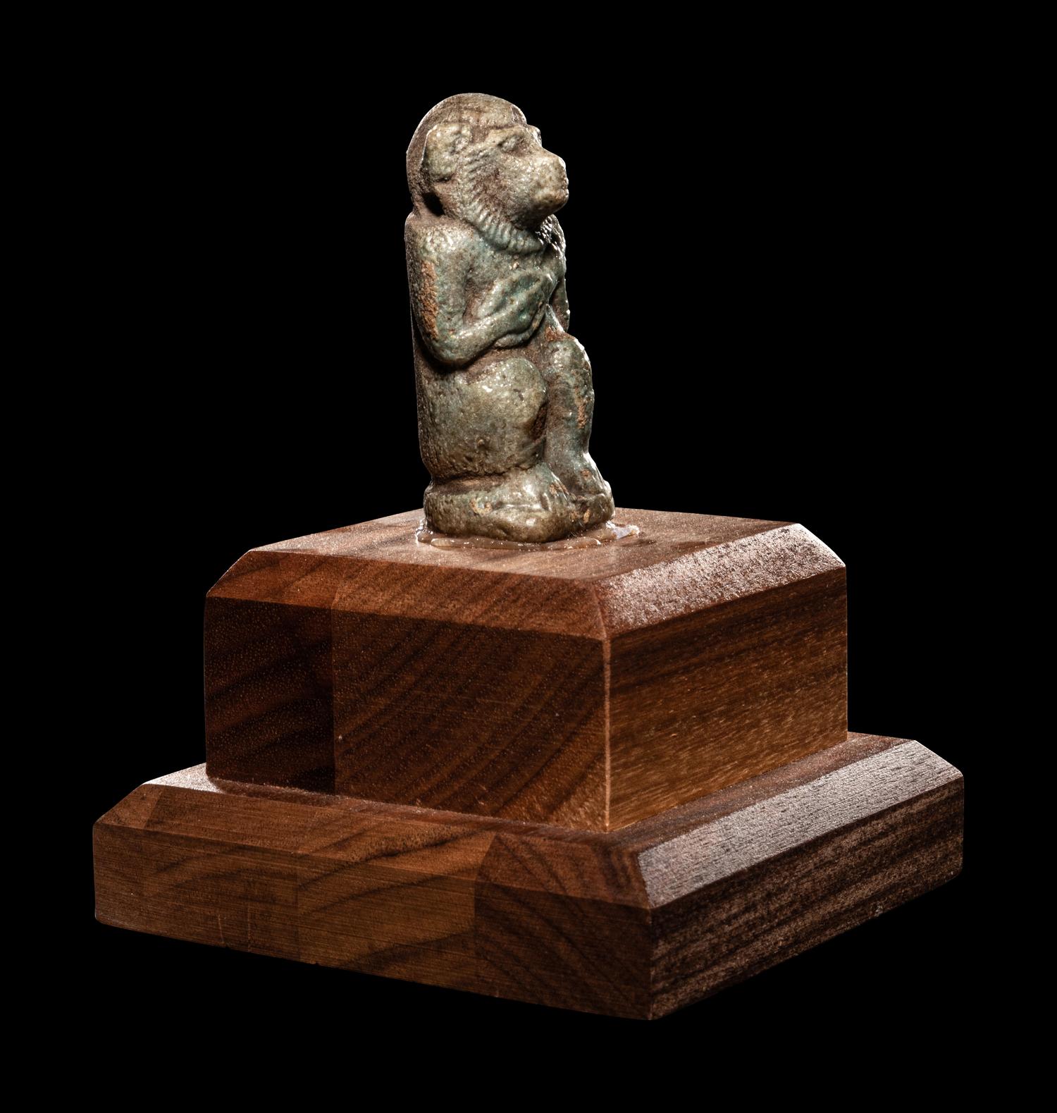 An Egyptian Faience Baboon with Musical Instrument