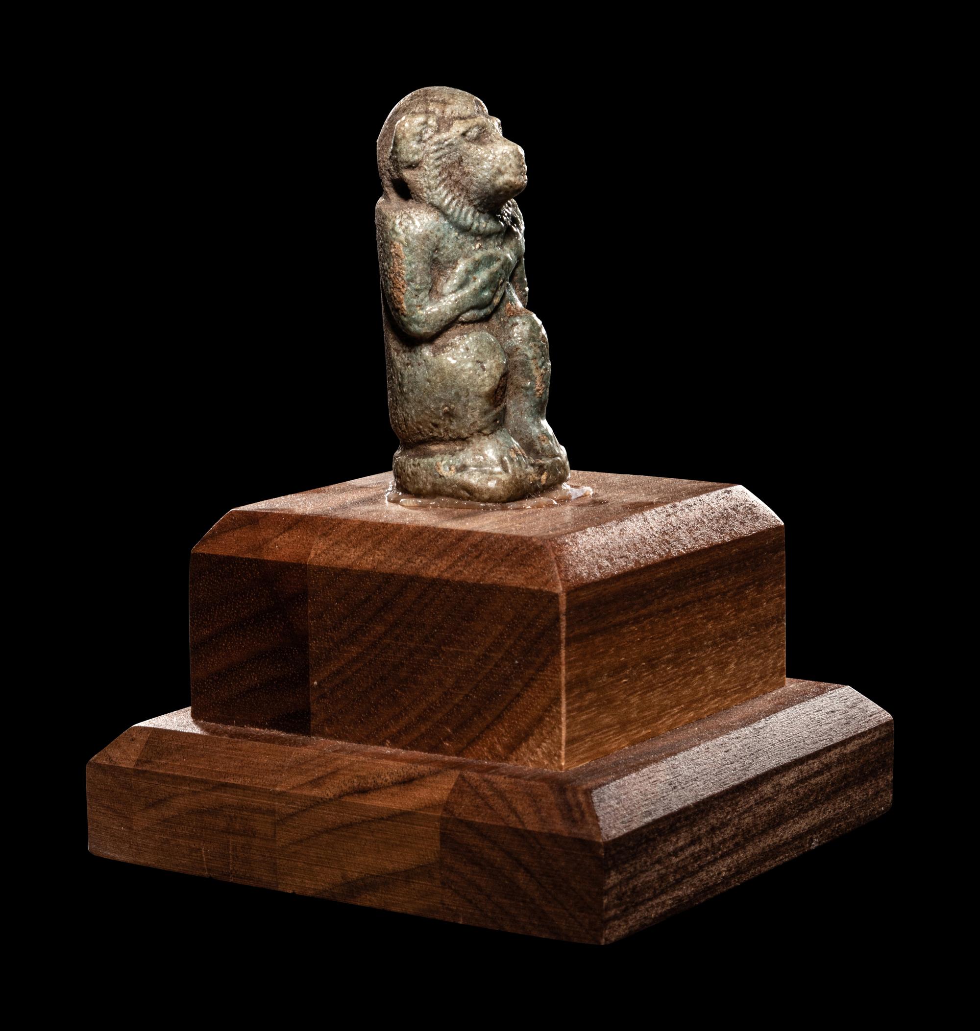 An Egyptian Faience Baboon with Musical Instrument