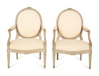 A Set of Four Louis XVI Grey-Painted and Parcel Gilt Fauteuils