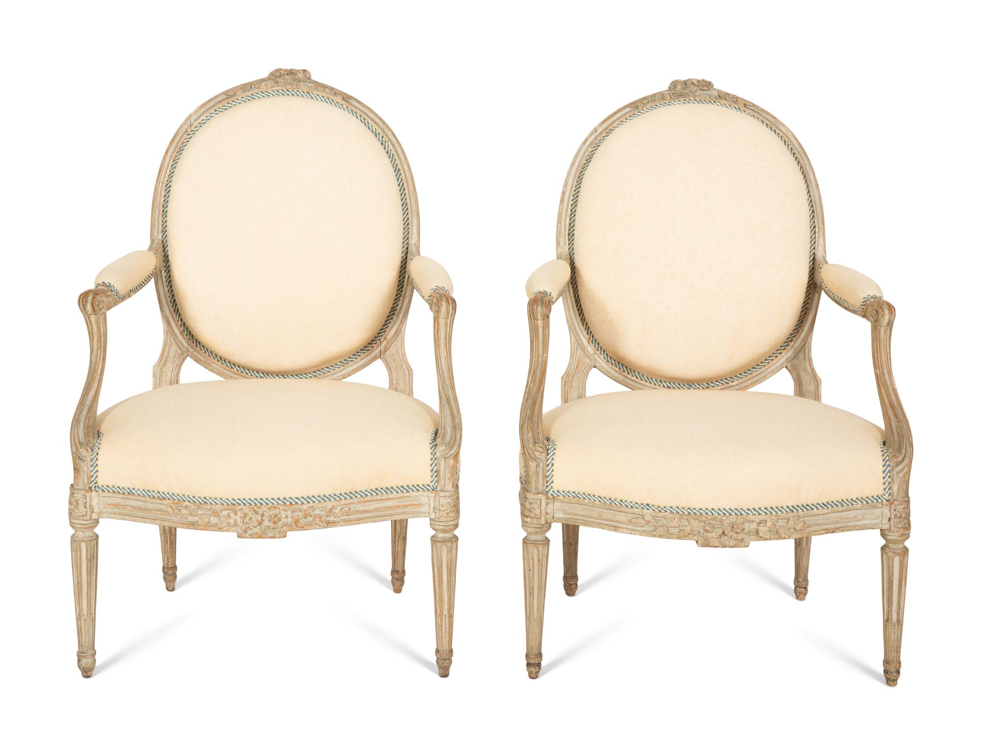 A Set of Four Louis XVI Grey-Painted and Parcel Gilt Fauteuils