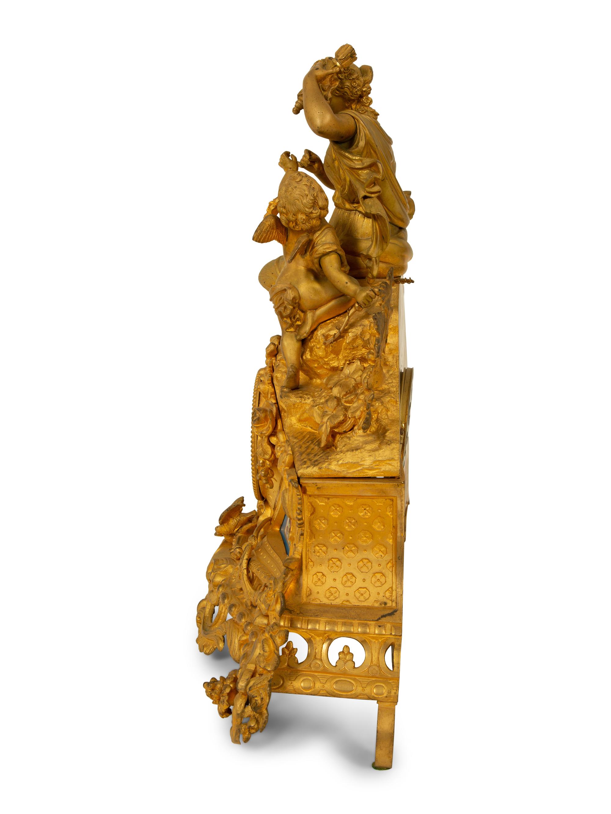 A Louis XV Style Gilt Bronze and Porcelain Inset Mantel Clock — 19TH CENTURY