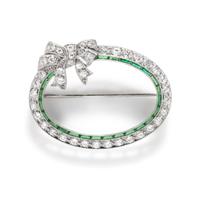 ART DECO, PLATINUM, DIAMOND, AND SYNTHETIC EMERALD BOW BROOCH