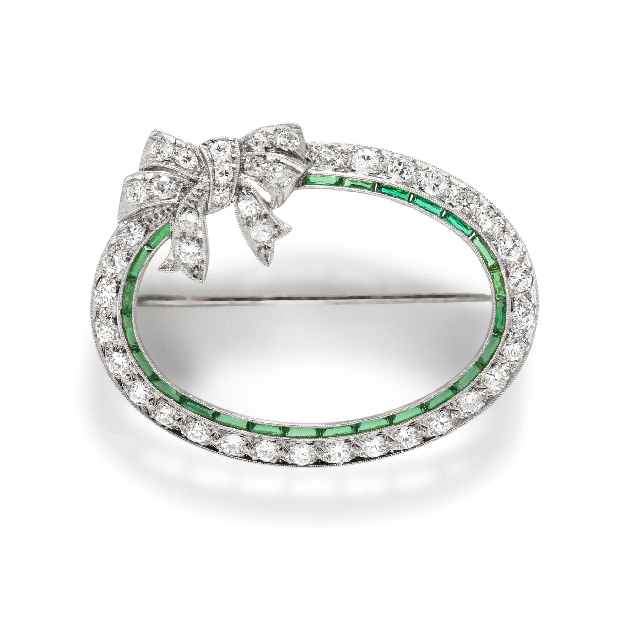 ART DECO, PLATINUM, DIAMOND, AND SYNTHETIC EMERALD BOW BROOCH