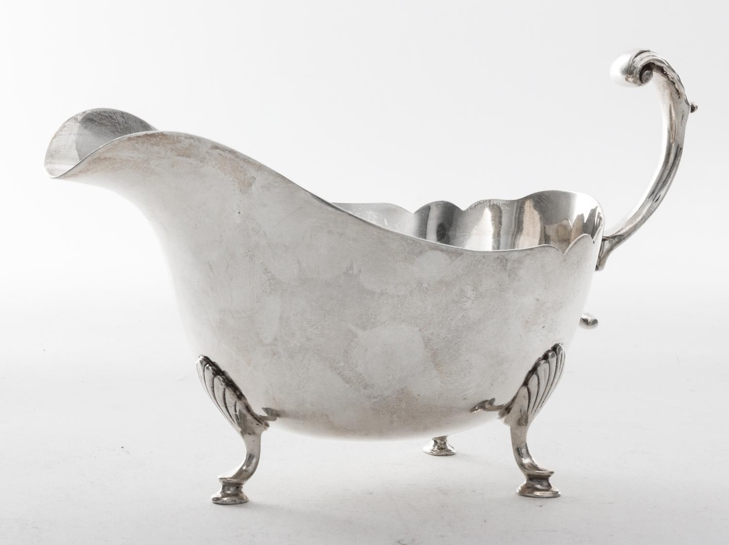 An American Silver Sauce Boat, Revere Silversmiths, Brooklyn, NY, 20th Century, Georgian style, of boat form raised on three pad feet,