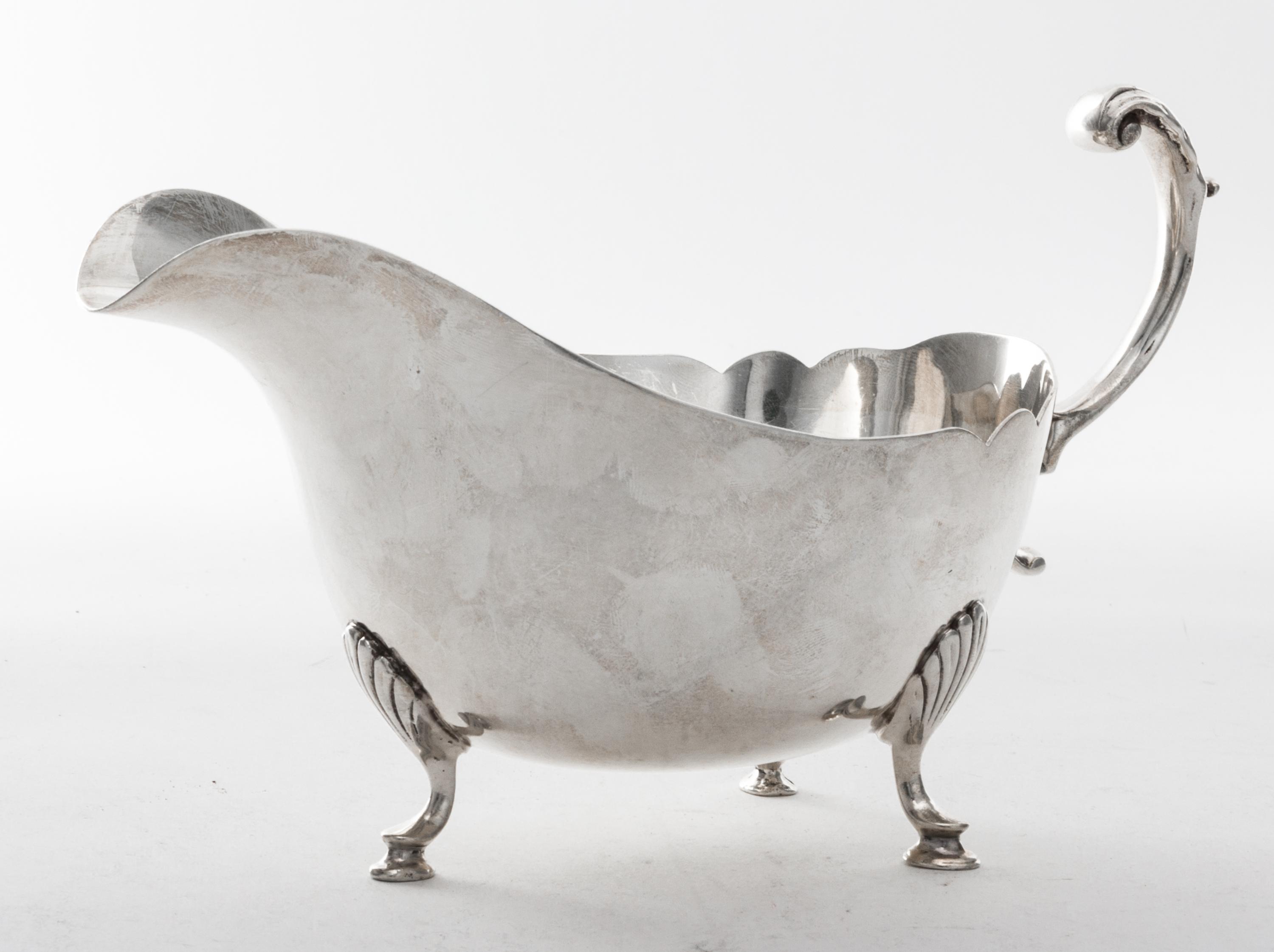 An American Silver Sauce Boat, Revere Silversmiths, Brooklyn, NY, 20th Century, Georgian style, of boat form raised on three pad feet,