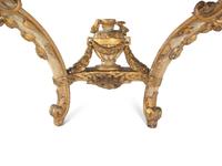 An Italian Rococo Parcel-Gilt and White-Painted Carved Wood Marble-Top Console Table
