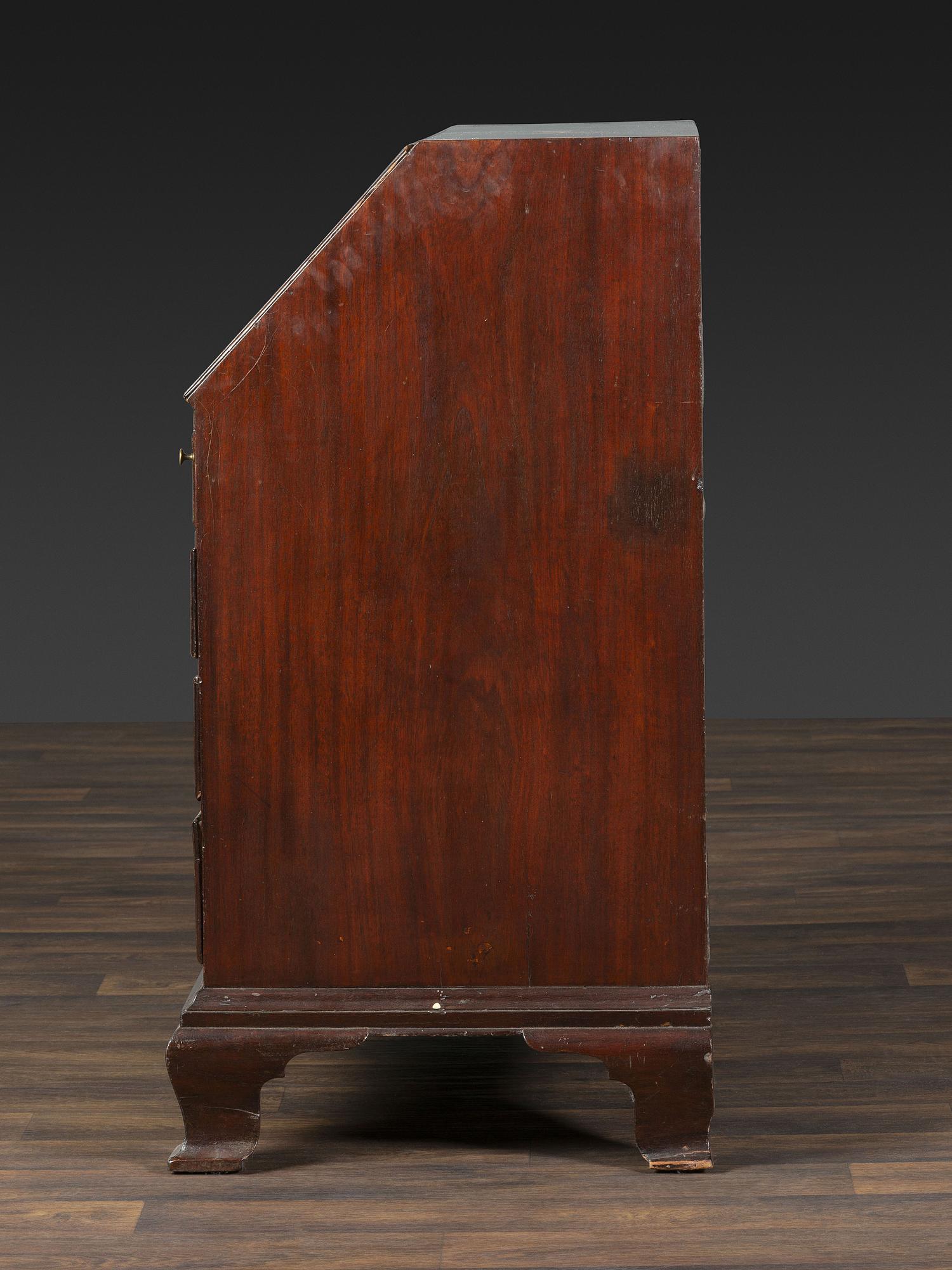 A Chippendale Figured and Shell-Carved Mahogany Slant Front Desk