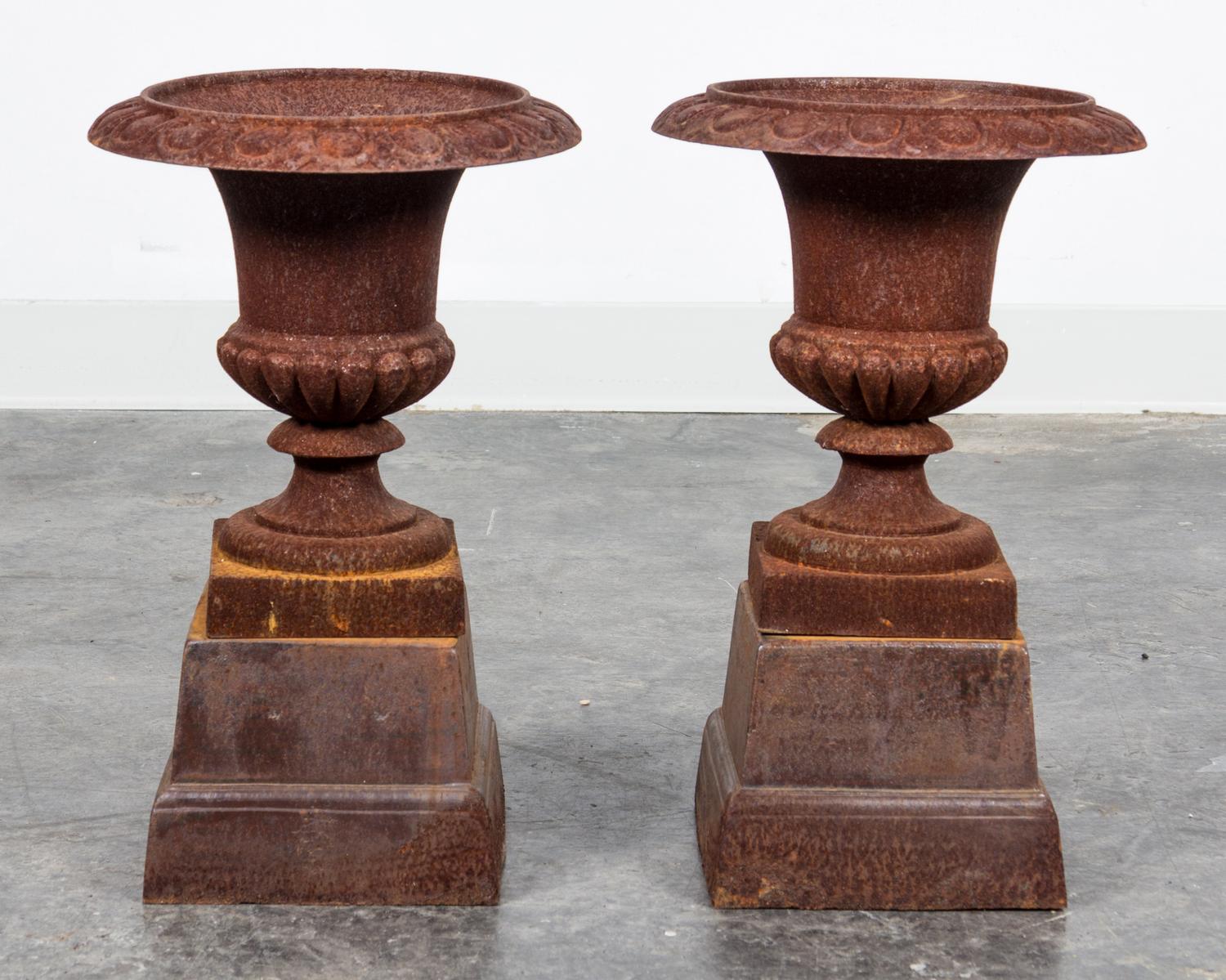 A Pair of Victorian Style Cast Iron Urns Height 12 1/2 inches.