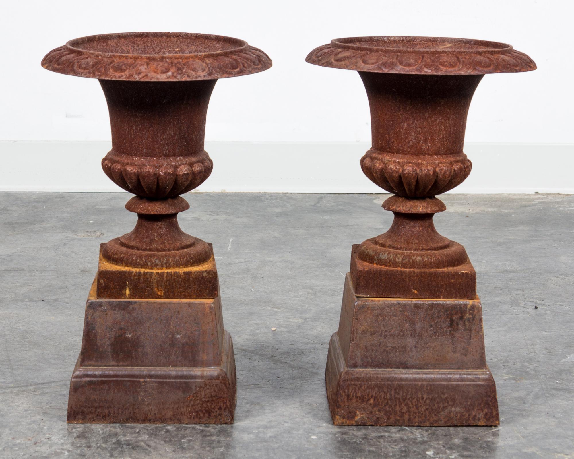 A Pair of Victorian Style Cast Iron Urns Height 12 1/2 inches.