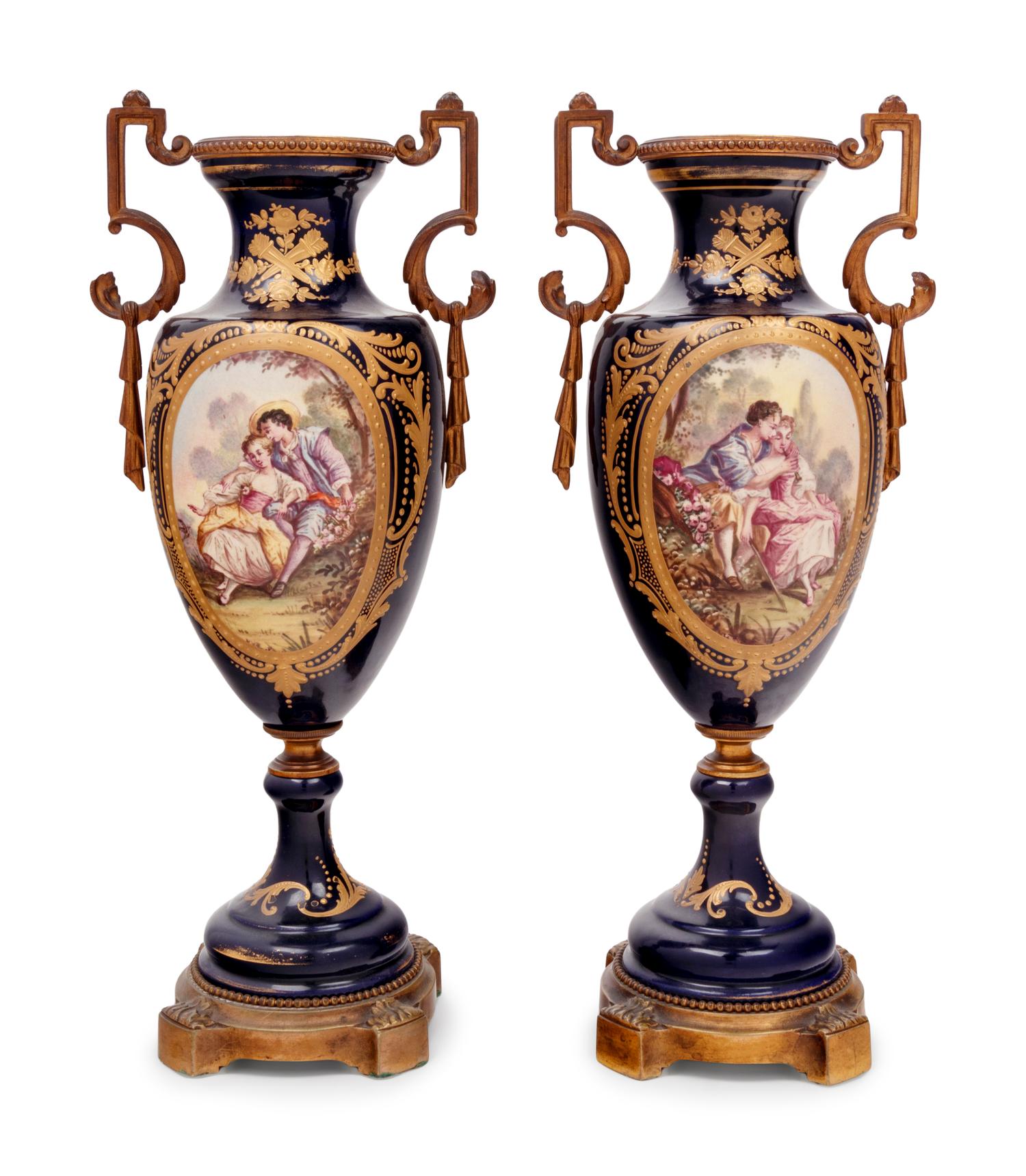 A Pair of Sèvres Style Gilt Bronze Mounted Porcelain Urns