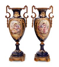 A Pair of Sèvres Style Gilt Bronze Mounted Porcelain Urns