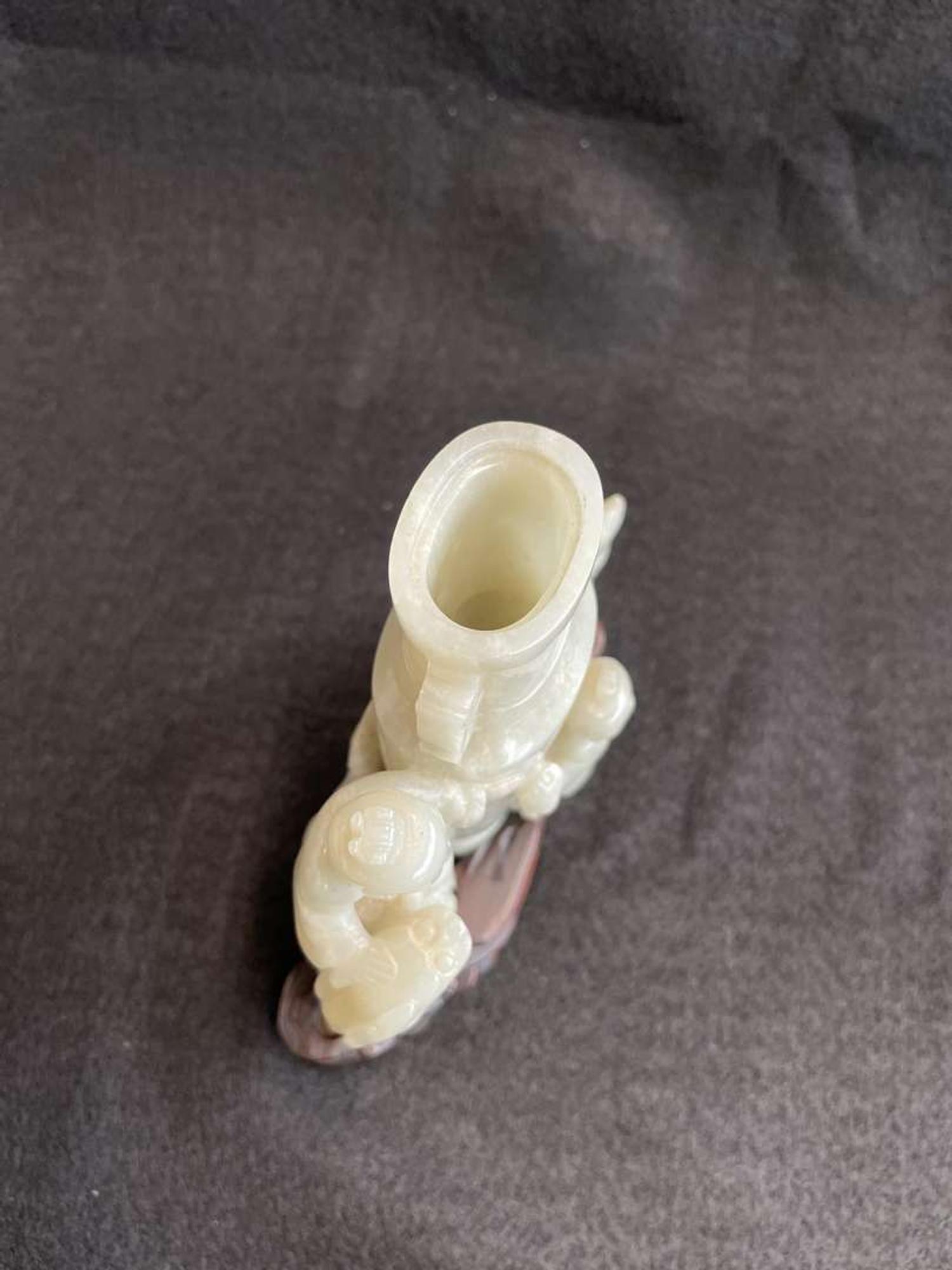 A Chinese jade "Boys, Kylin and Phoenix" vase on carved wood stand 玉雕童子凤鸟花樽及底座